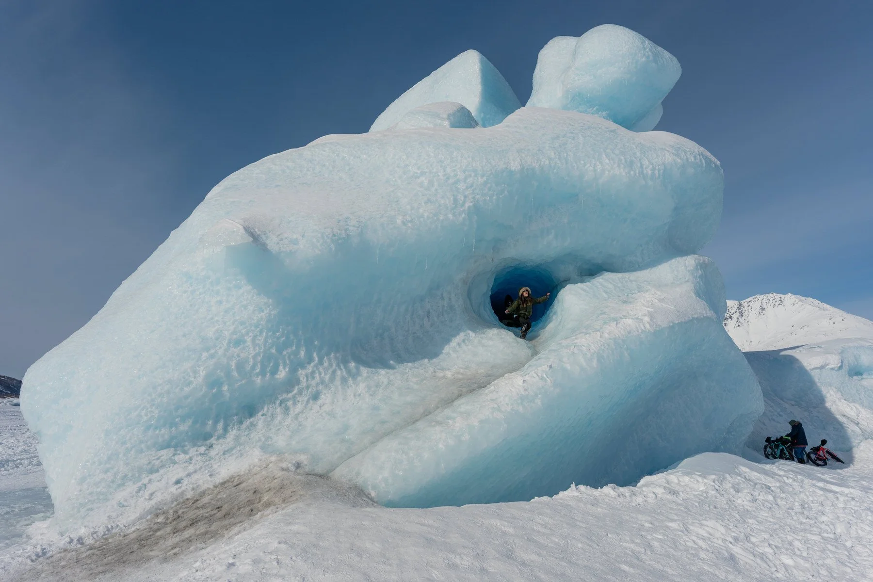 portrait of a girl coming out of a tunnel in an iceberg near the knik glacier