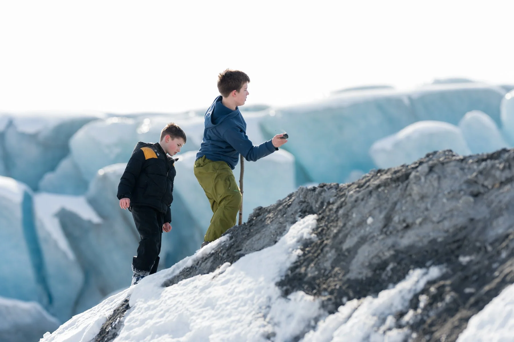 Kids playing on the knik glacier and throwing rocks.