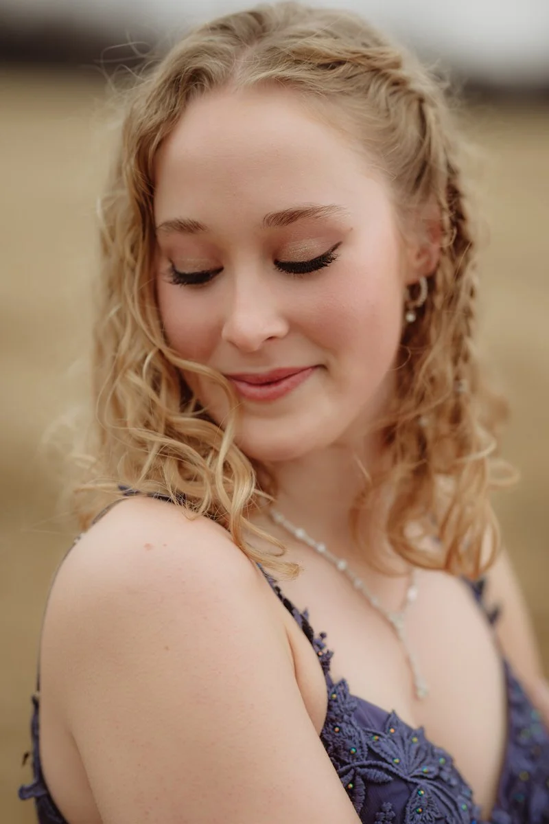 High School portrait of a girl looking down showing off her eyemakeup