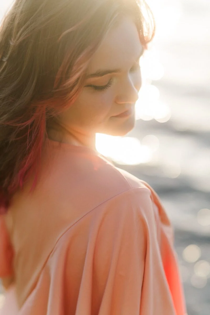 Close up portrait of a teenager wearing a peach dress on the oregon coast.