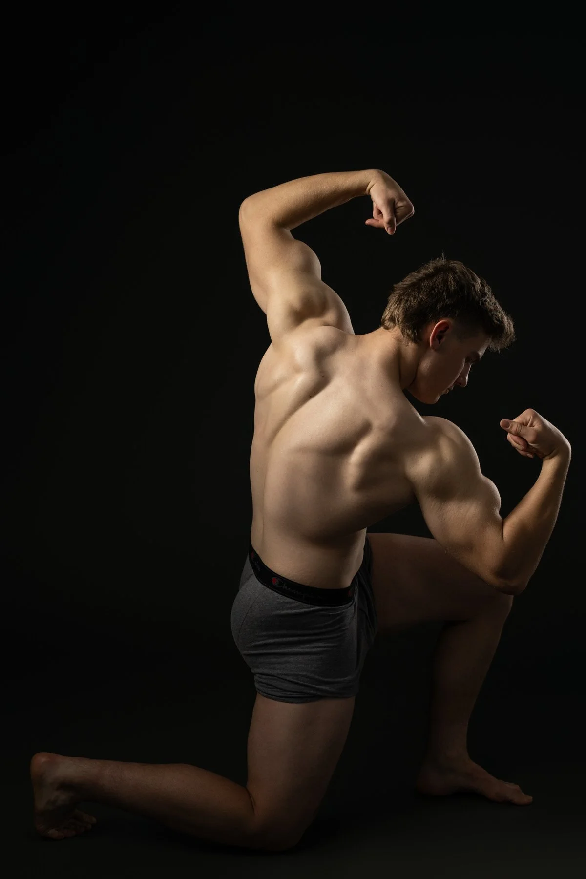 Portrait of a body Builder in Alaska flexing his muscles in the studio