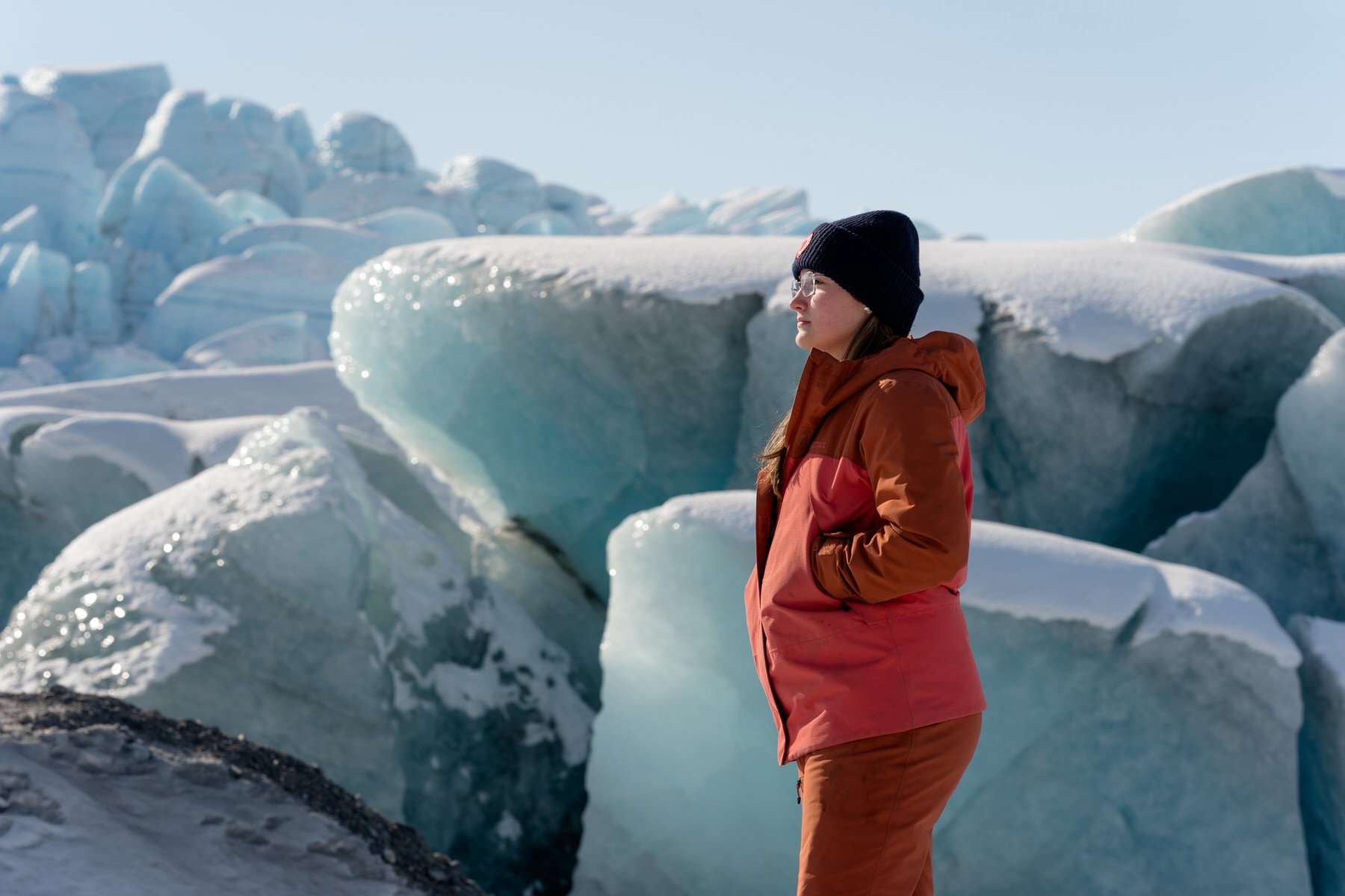 Portrait of a girl in an Orange coat on the knik glacier
