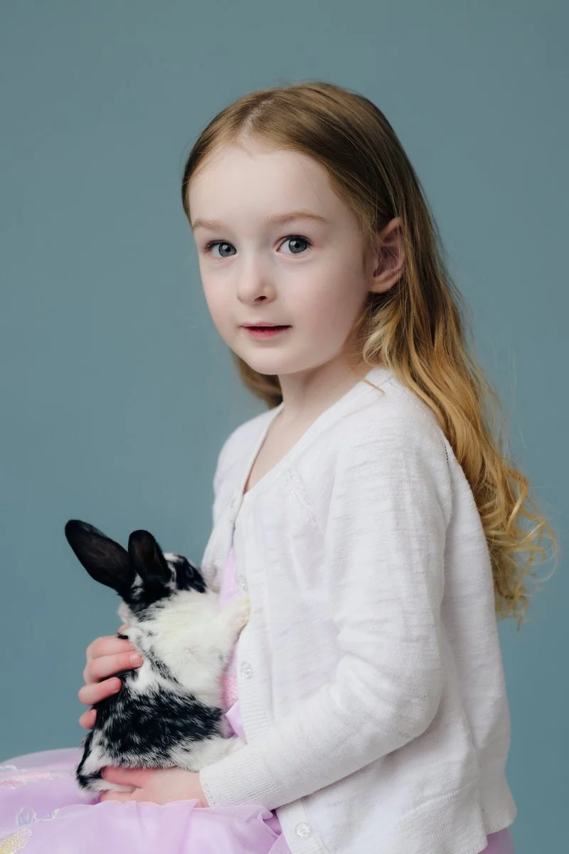 portrait of a girl holding a rabbit during an easter session. 