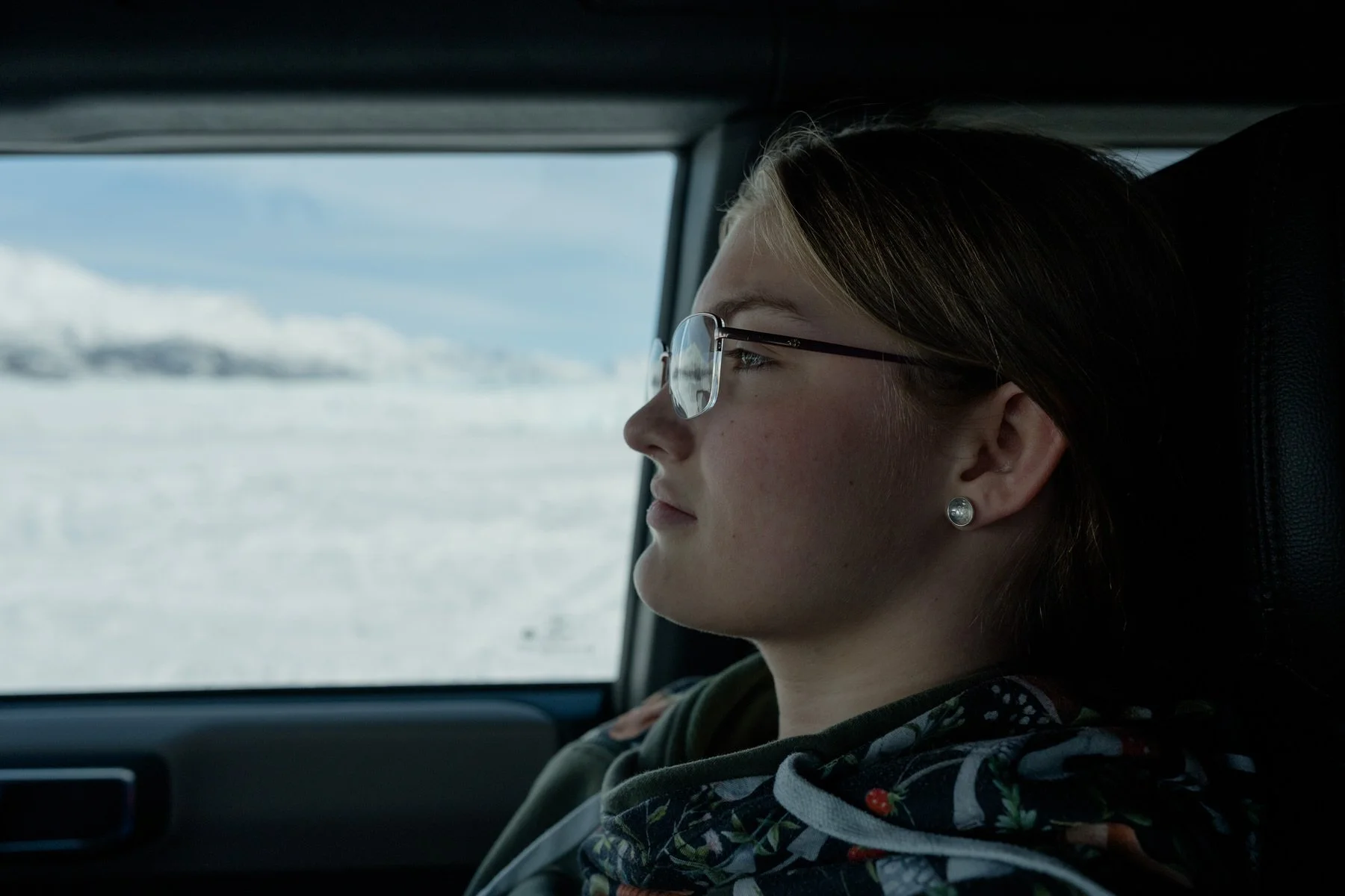 Portrait of a girl sitting in a car at the end of a long day on the knik glacier
