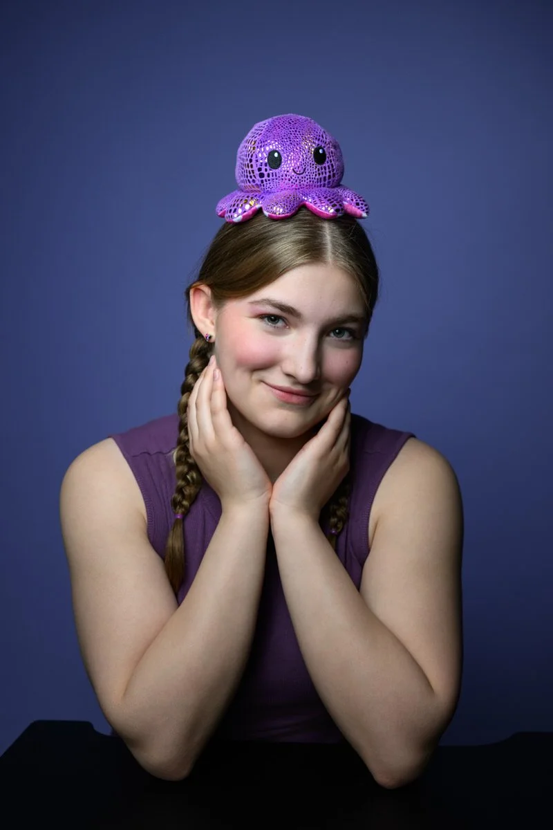 Portrait of a girl with a plush toy on her head