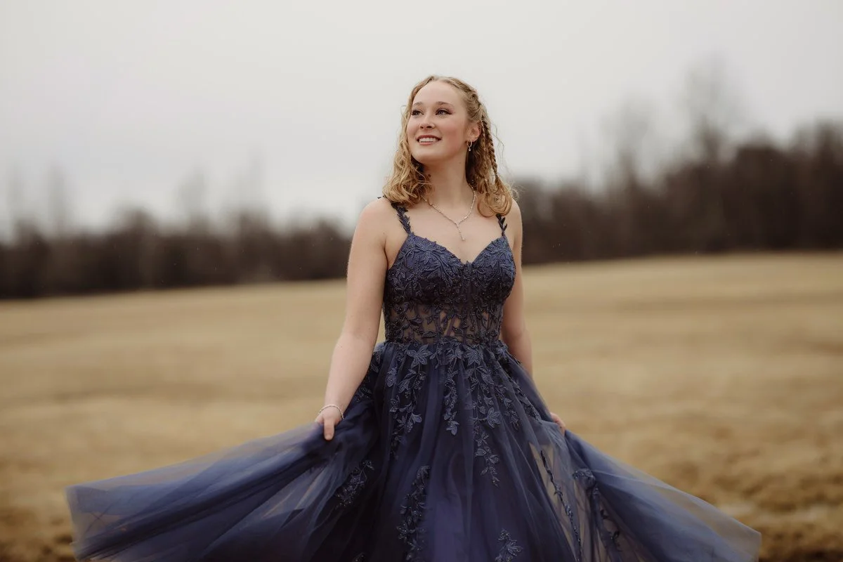 Girl in a blue prom dress in a field in Palmer alaska