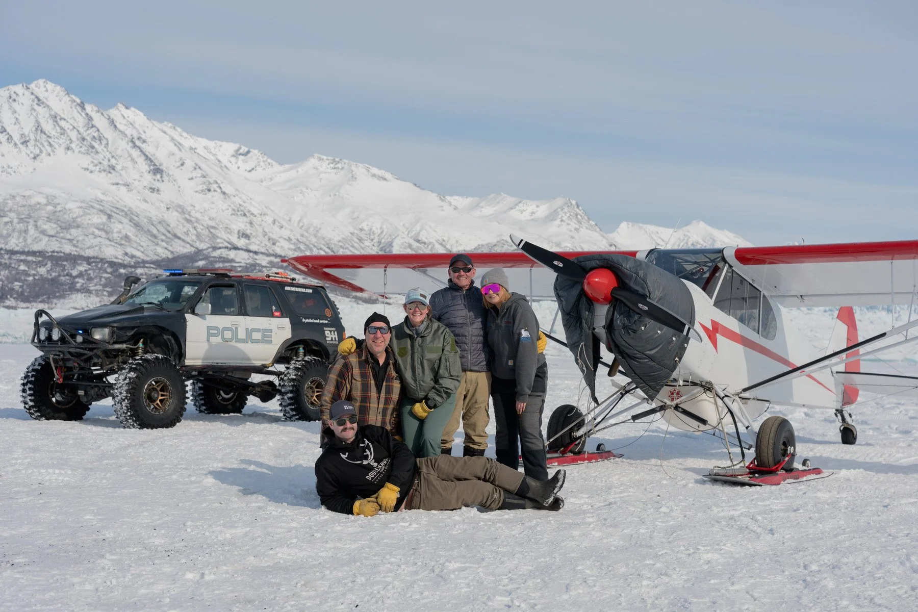 A bush plane, Off road vehicle on a gladier with family