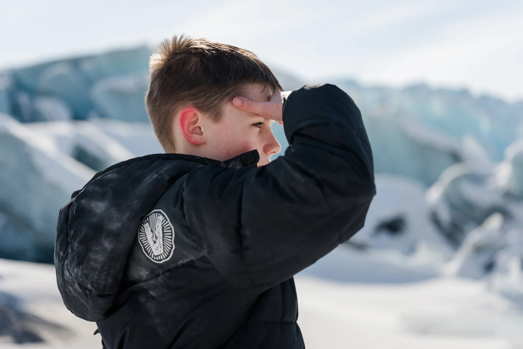 Portrait of a boy looking with the knik glacier behind him