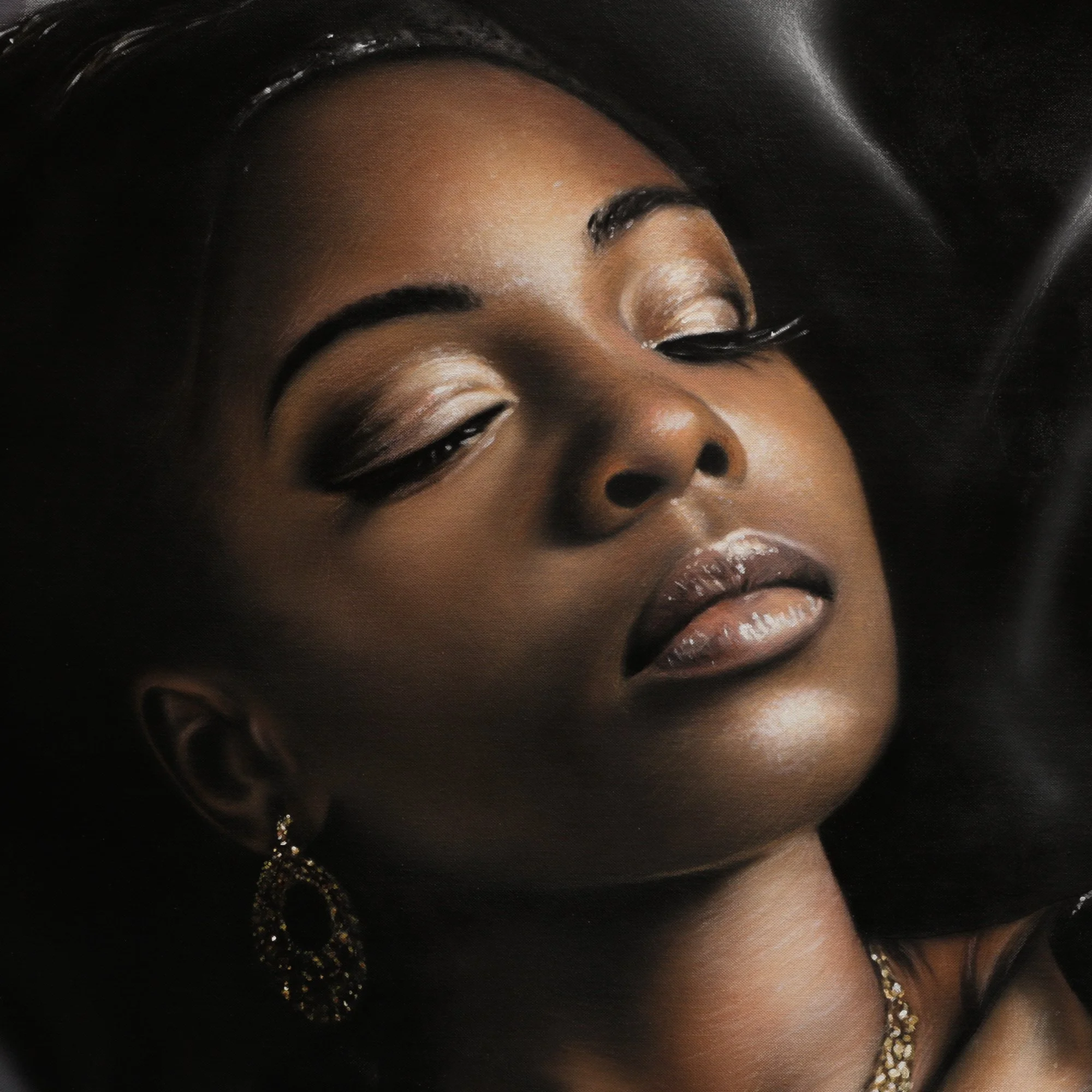 Black Beauty by Johannes Wessmark, a reclining woman in black lace lingerie and jewellery against glossy black satin.