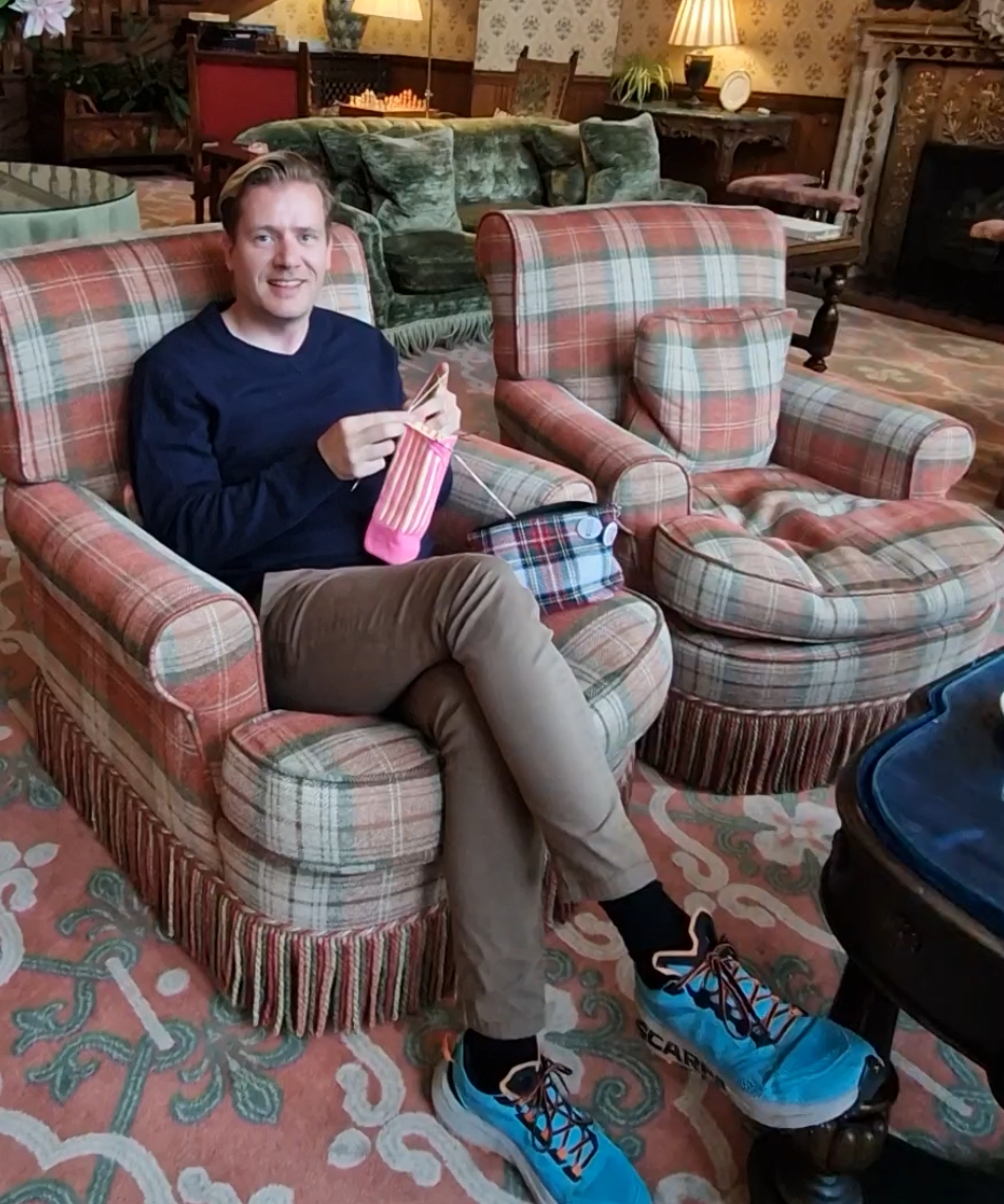 Norman Schwarze knitting at a castle