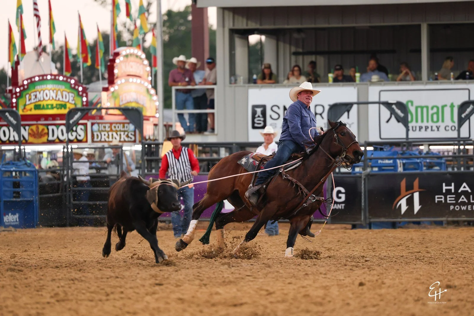 Gold Buckle Club box with Smarty Supply Co banners at the Mount Pleasant PRCA ProRodeo