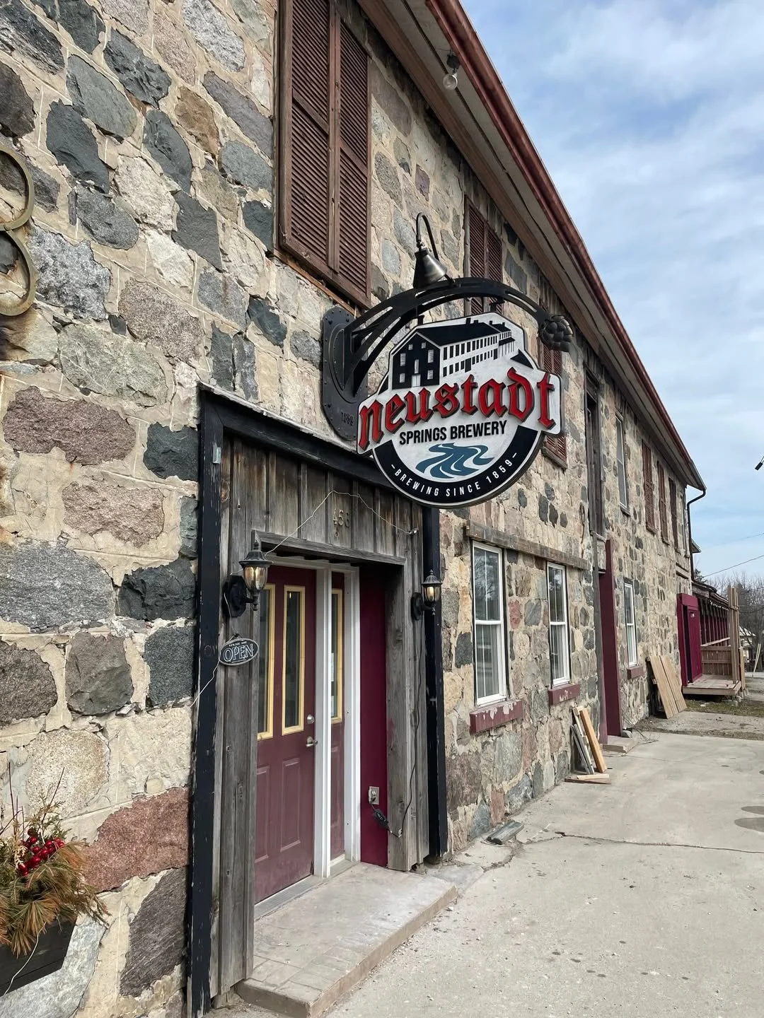 Stone building with a sign for Newstadt Springs Brewery - Signupsigns - Neustadt.