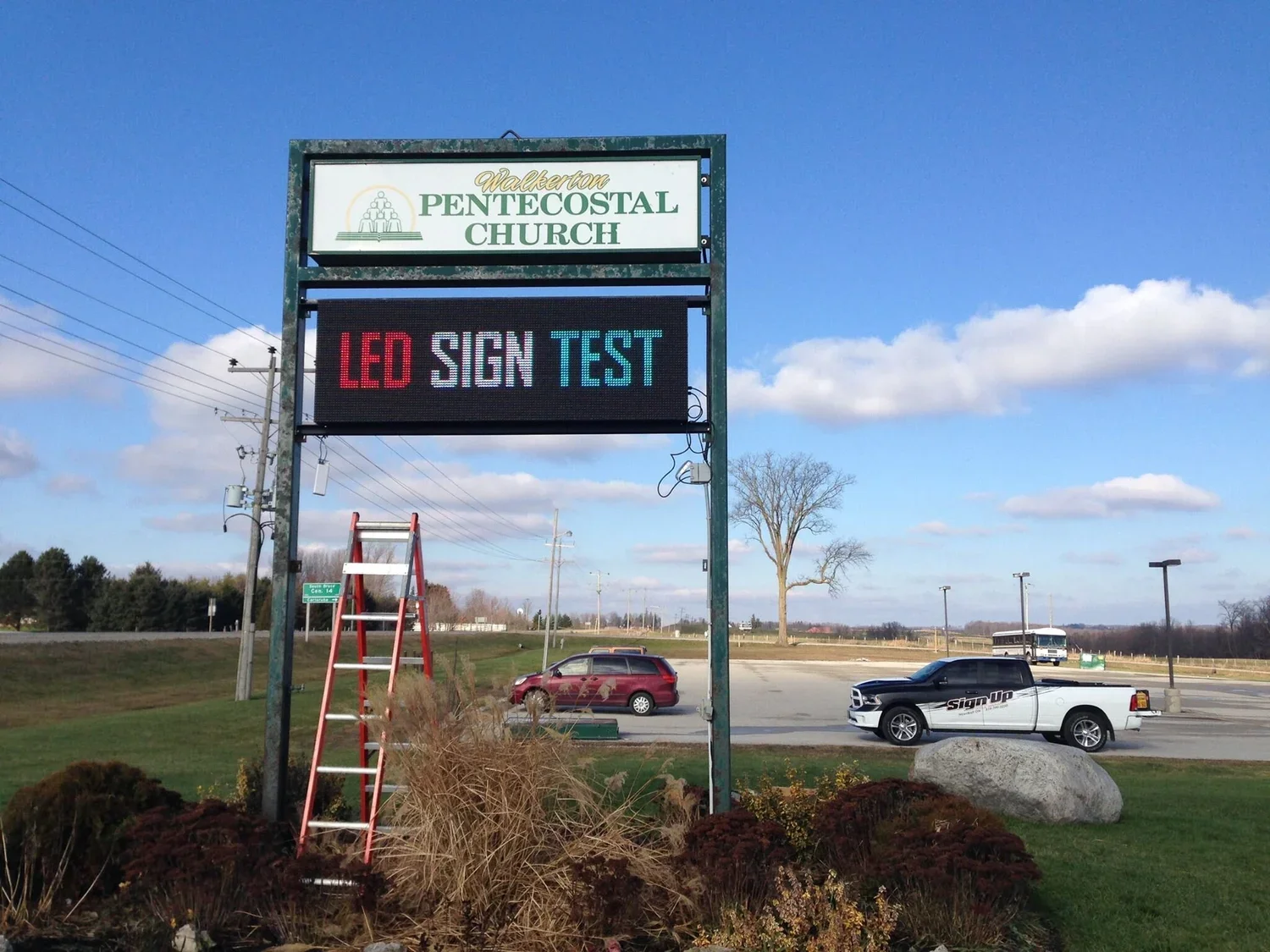 A digital sign outside Walkerton Pentecostal Church displays 'LED SIGN TEST' in red, white, and blue text - Signupsigns - Neustadt.