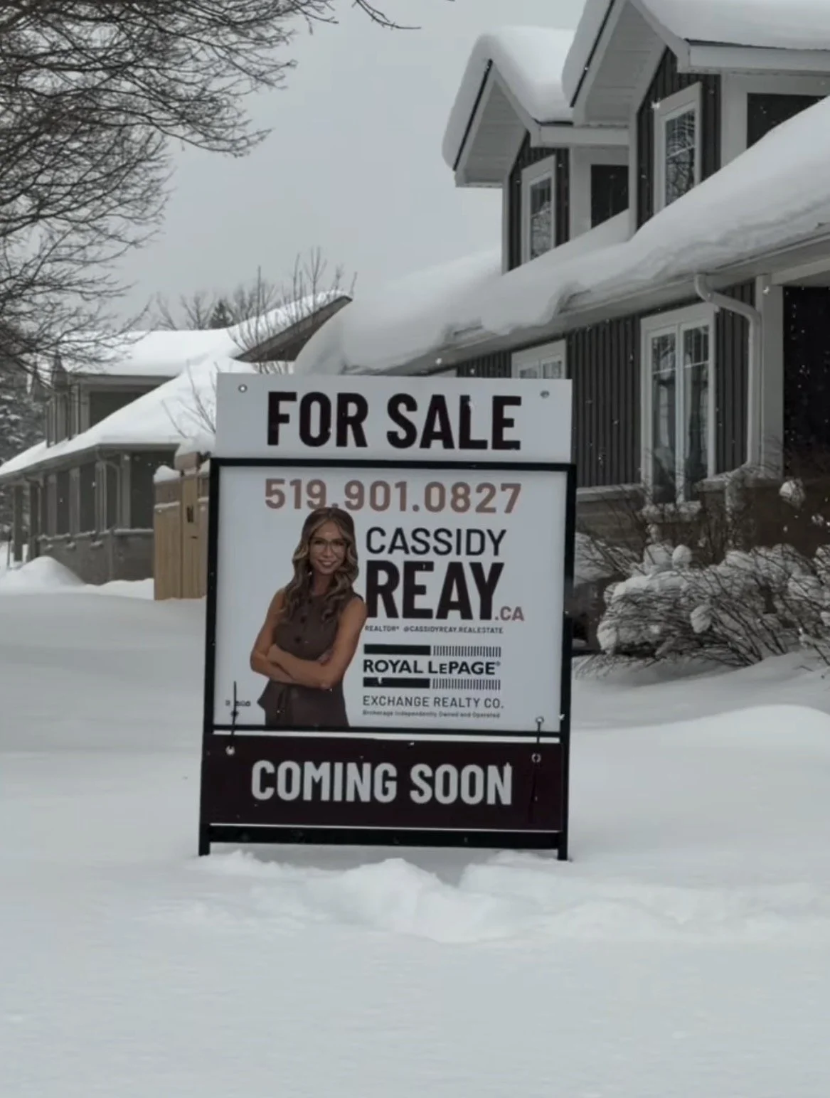 For sale sign in snow with contact information and a photo of Cassidy Reay, a real estate agent - Signupsigns - Neustadt.
