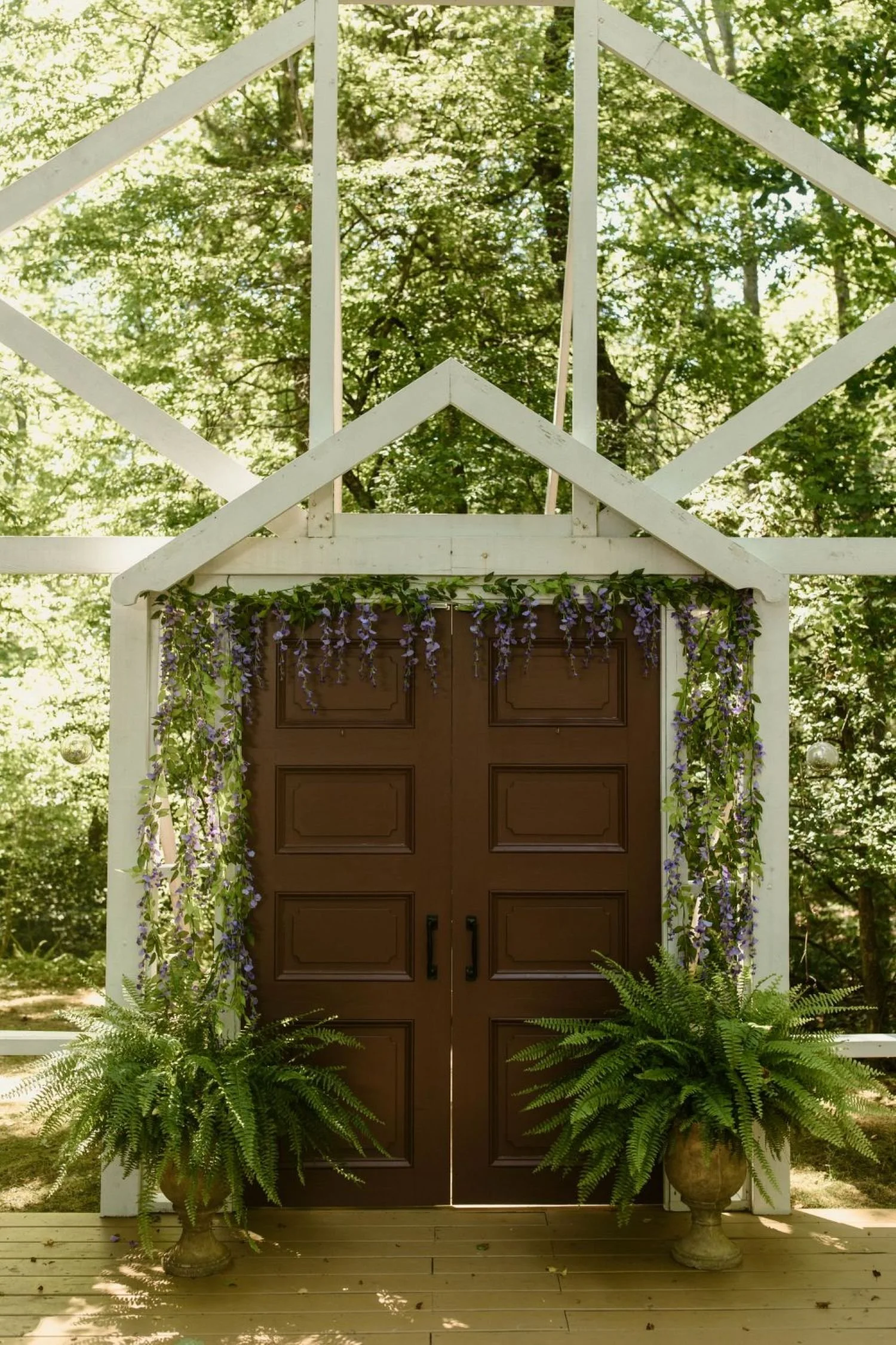 Main doors on the facade of the Chapel ceremony site located at Historic Jasmine, a woodland fairytale forest wedding venue in New Kent, Virginia.
