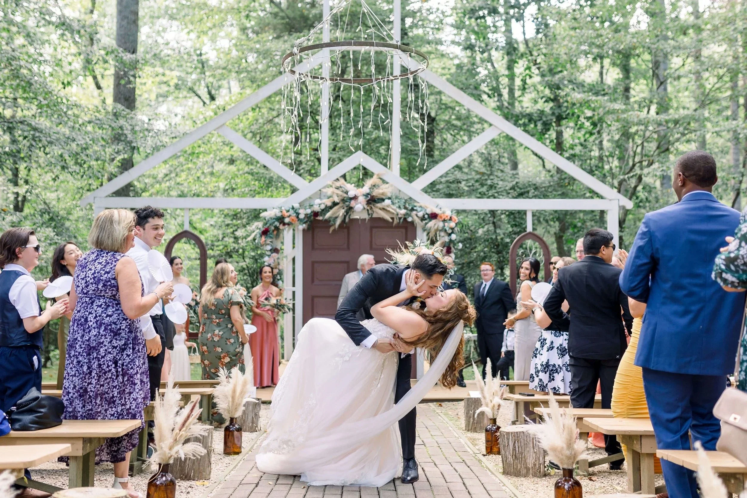 Newlyweds kiss at woodsy wedding ceremony in Virginia