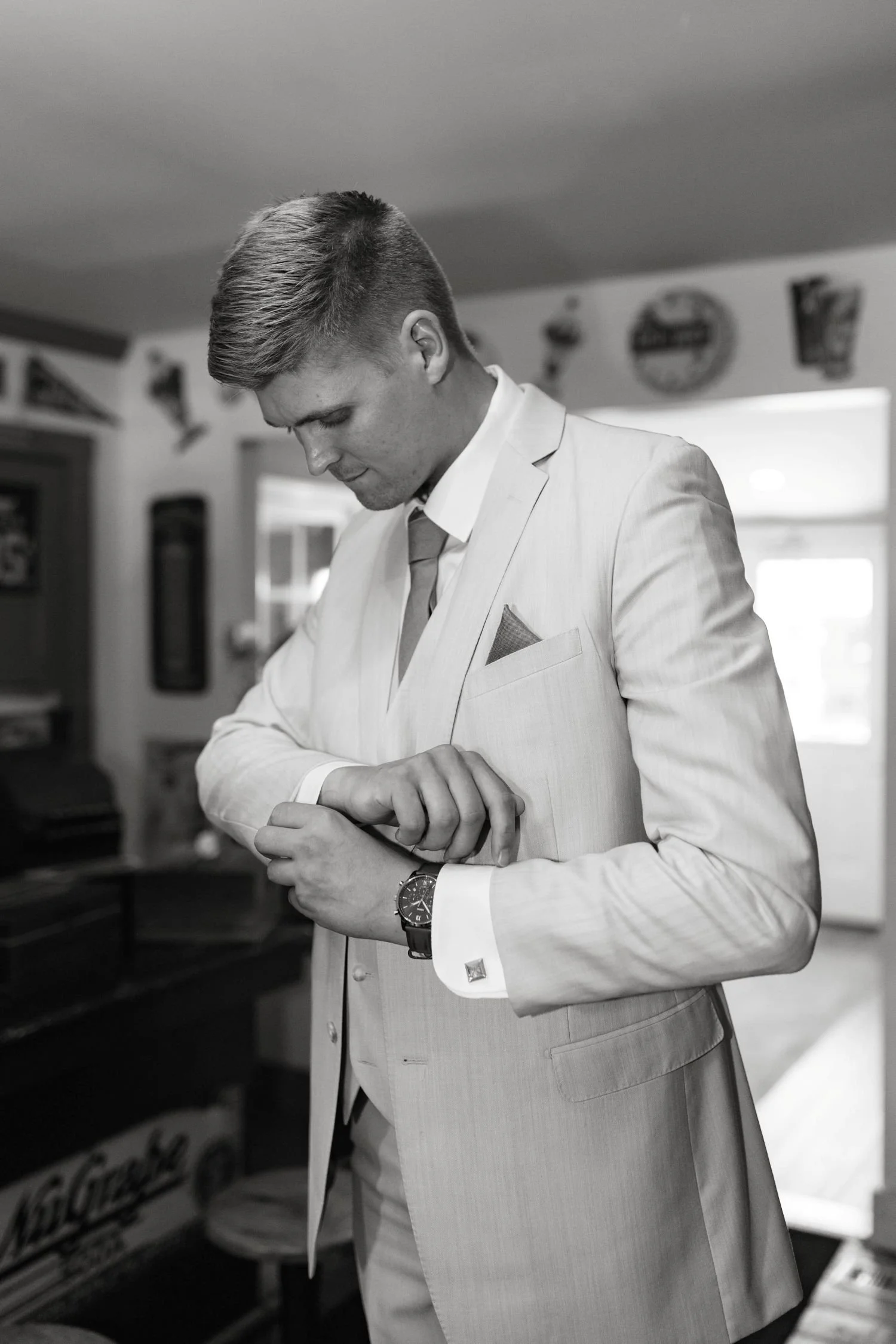 A groom fixes his cufflink before his wedding ceremony at Historic Jasmine, a private wedding venue in Providence Forge, VA.