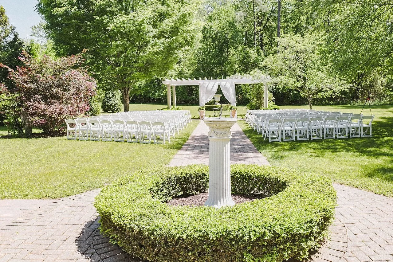 View of the main aisle of the Garden Pergola ceremony site at Historic Jasmine, a romantic wedding venue near Richmond, VA