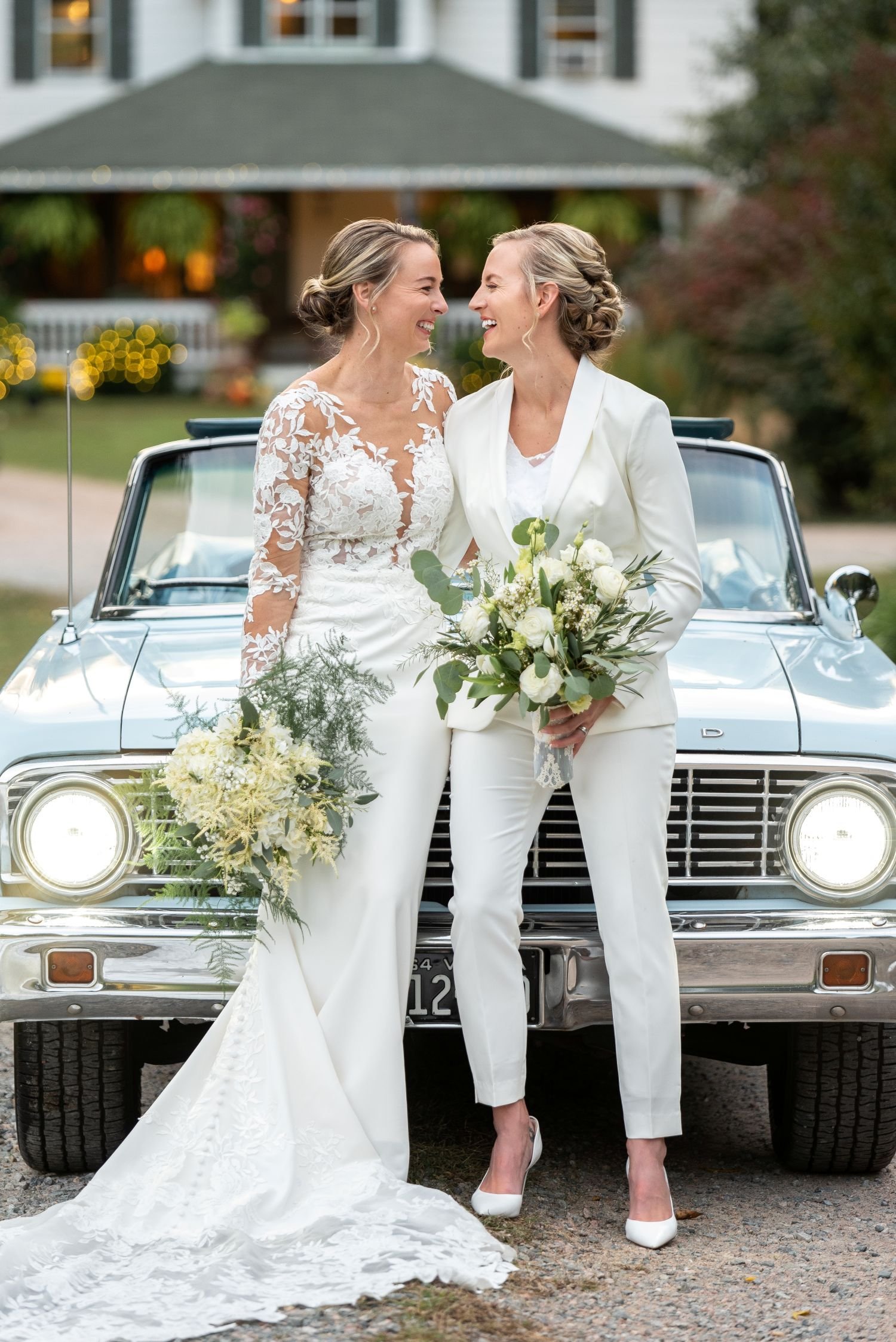 Brides pose for a wedding portrait in front of a classic car at Historic Jasmine, a LGBTQ+ friendly wedding venue located near Richmond, Virginia.