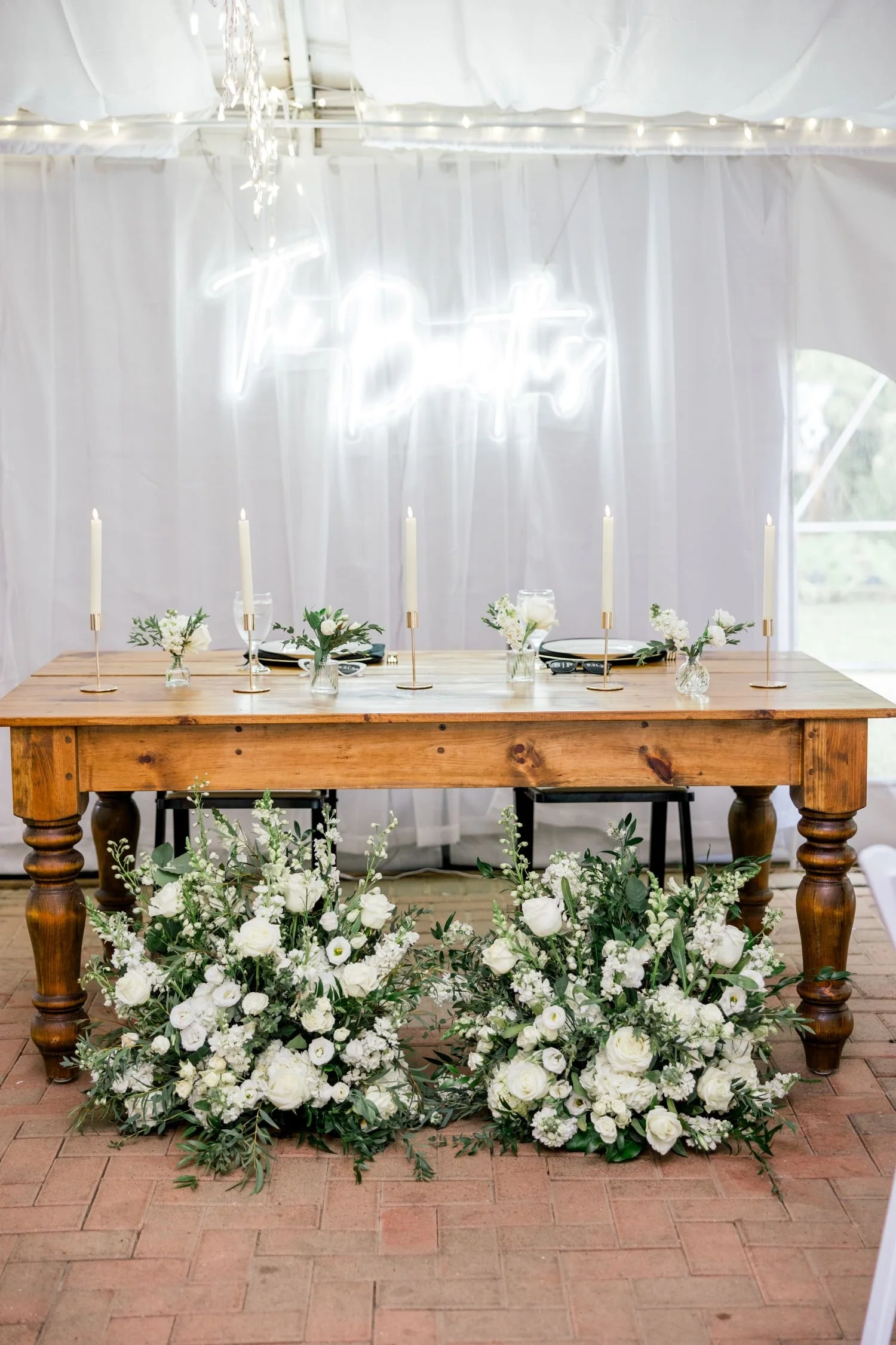 A wedding couple's rustic farmhouse sweetheart tables decor  at a reception hosted in New Kent County, Virginia.