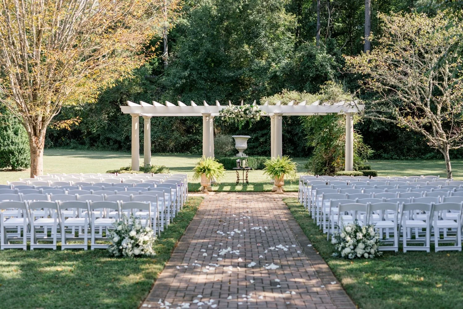 The Garden Pergola ceremony site ready to host an elegant garden wedding at Historic Jasmine, a unique wedding venue in New Kent, VA.