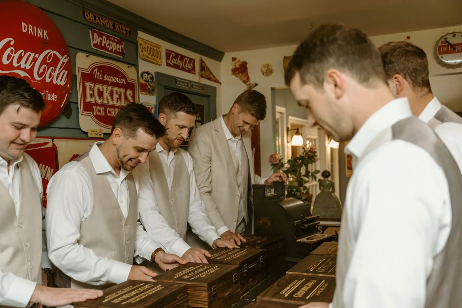 A groom presents his groomsmen with a gift of personalized wooden cigar boxes at Historic Jasmine, a private wedding venue in New Kent, Virginia.