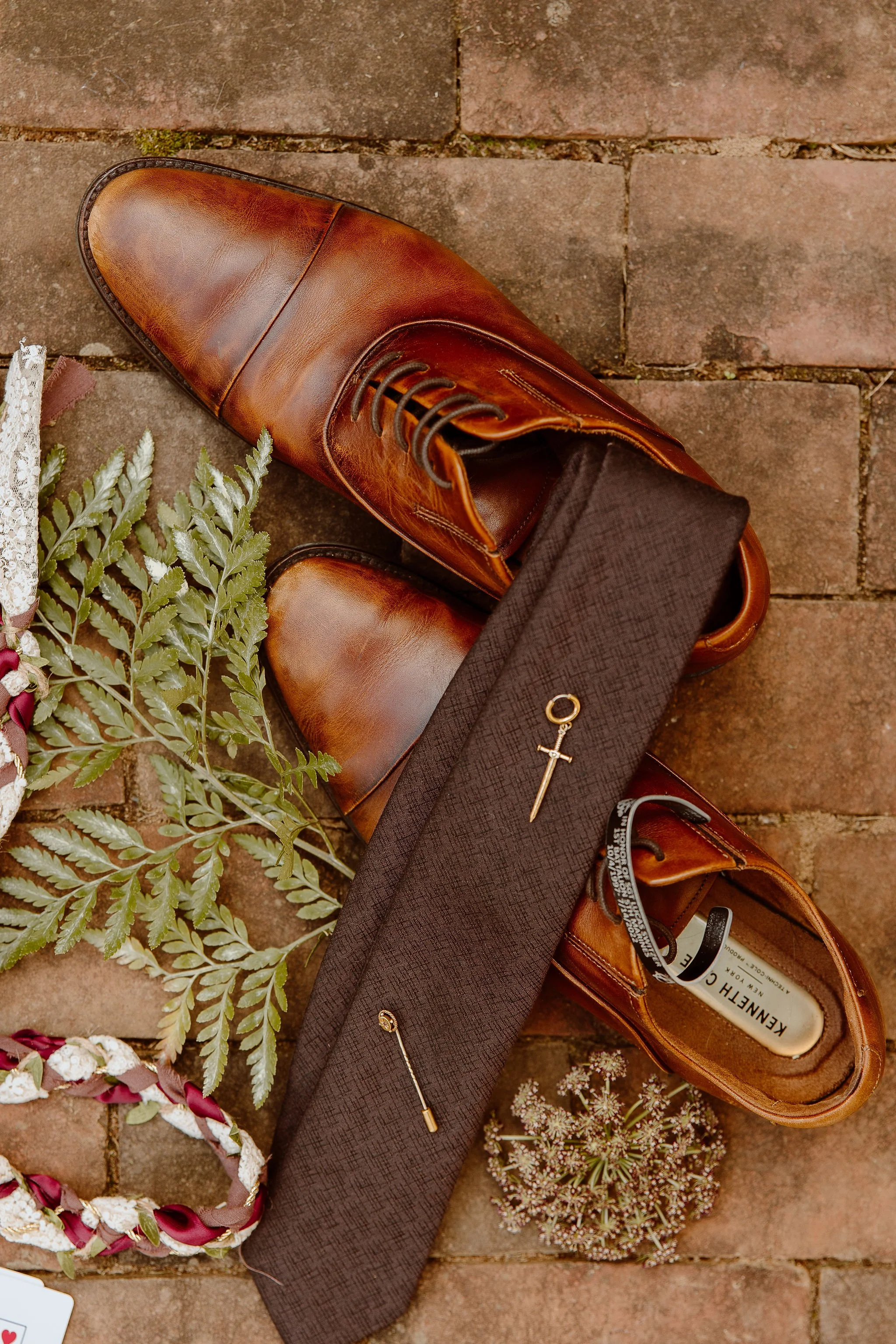 Detail view of groom's dress shoes and brown tie at Historic Jasmine, a private wedding venue in Greater Richmond, Virginia.