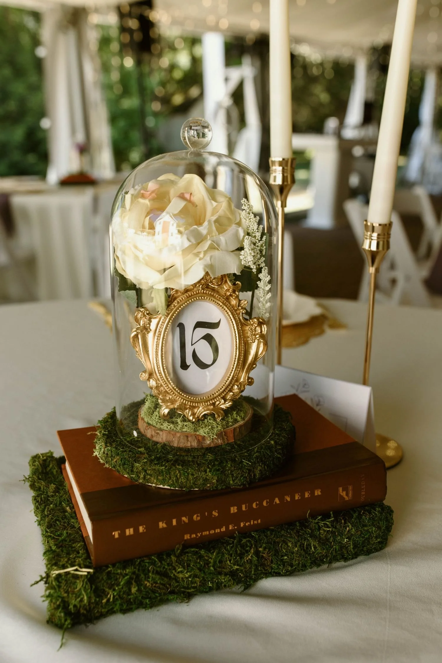 Guest table centerpiece for a woodsy fairytale wedding reception hosted at Historic Jasmine, a wedding venue near Richmond, Virginia.
