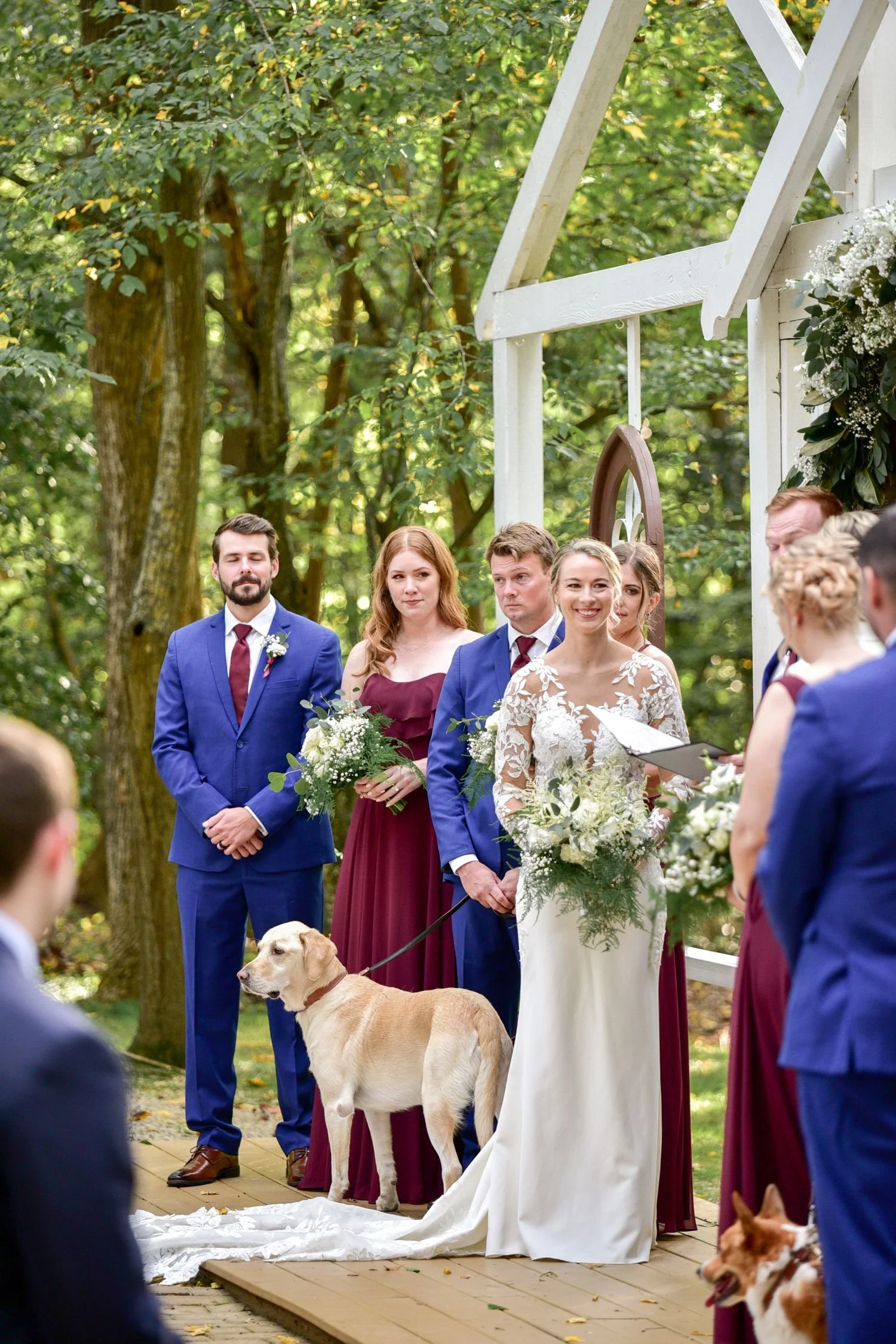 A bride, her dog, and her wedding party pose at a Chapel ceremony at Historic Jasmine, a pet-friendly wedding venue near Richmond, VA.