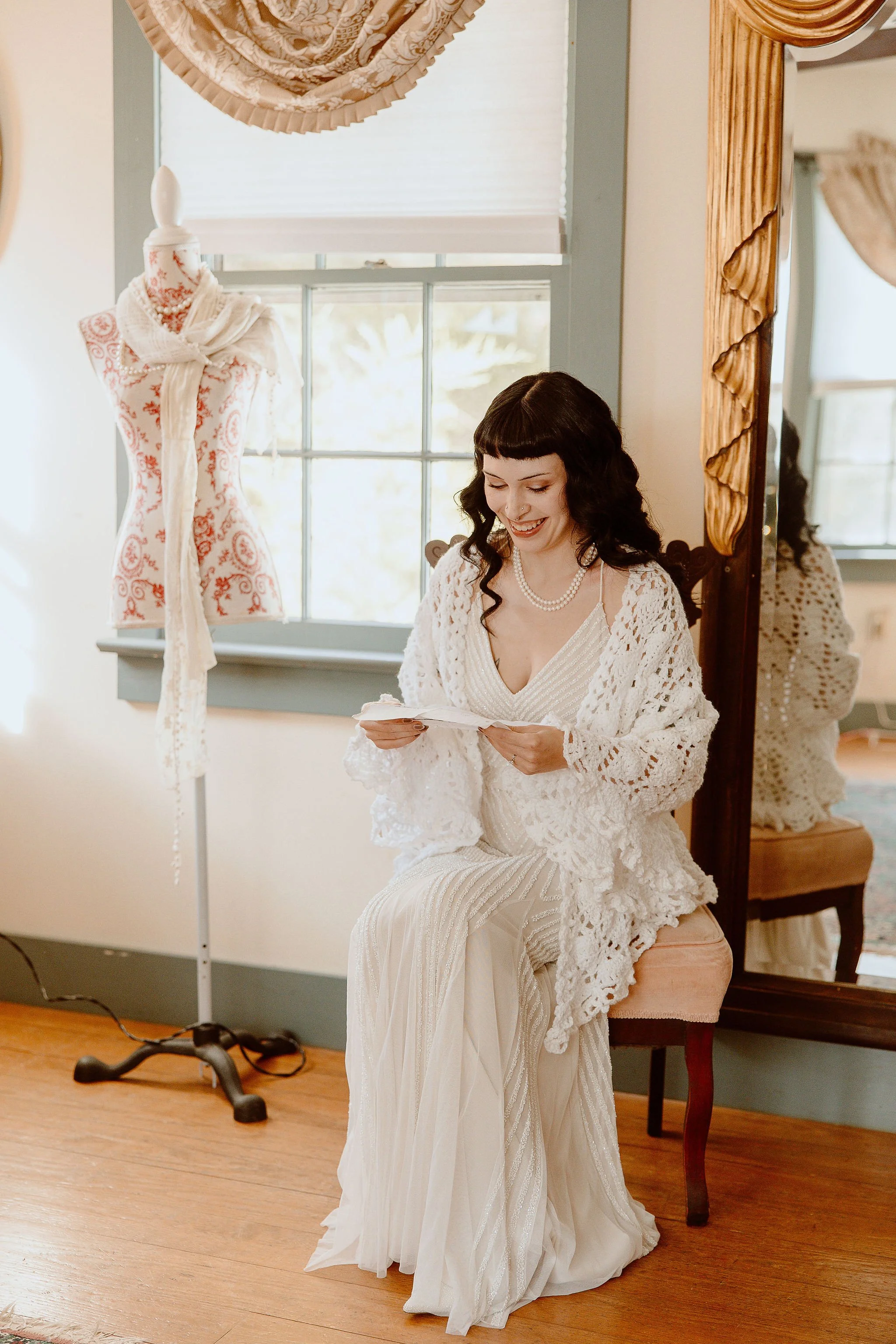A bride a note from the groom before the ceremony at Historic Jasmine, a private wedding venue in Greater Richmond, VA.