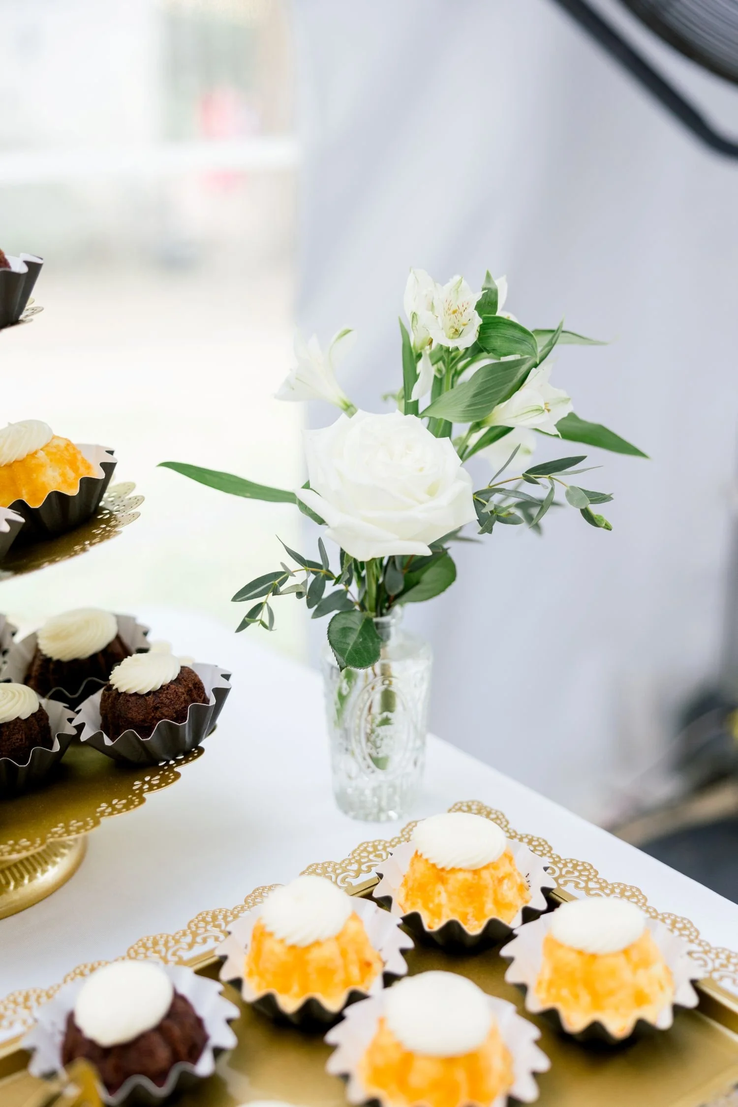 Mini bundt cakes displayed at a garden wedding reception hosted at Historic Jasmine, a New Kent, VA wedding venue.