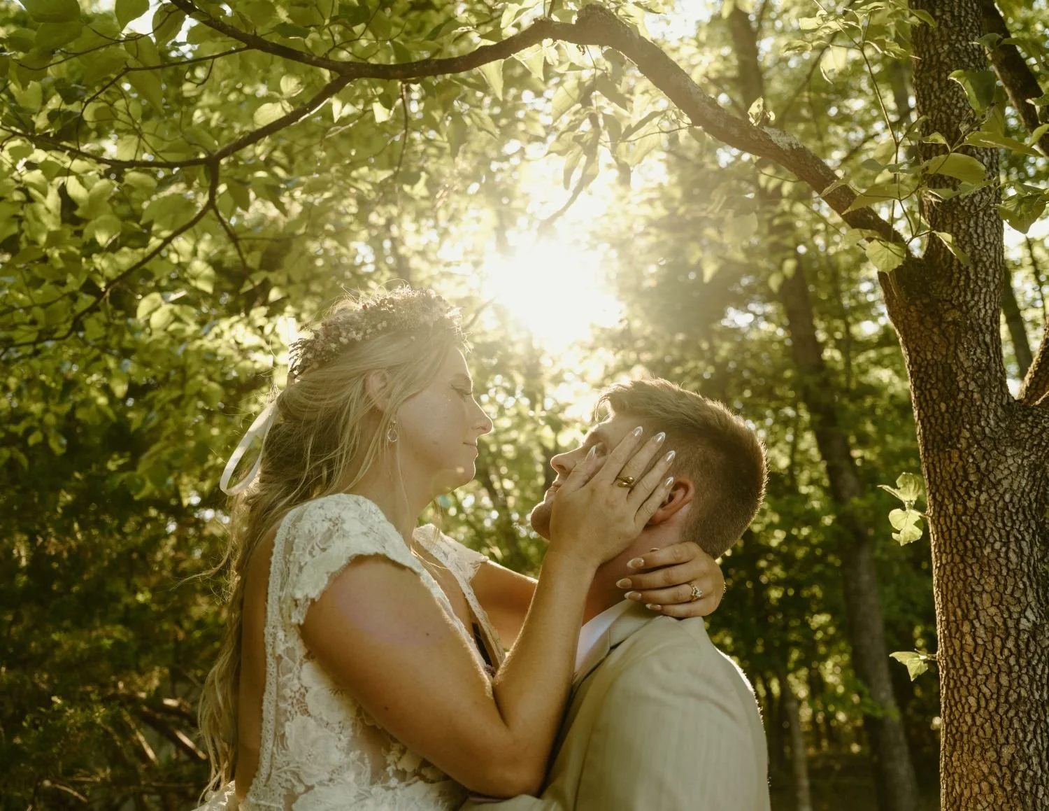 Bride and groom kissing after wedding ceremony as the sun filters through the forest fairytale setting at Historic Jasmine, a private wedding venue in Greater Richmond Area, Virginia.