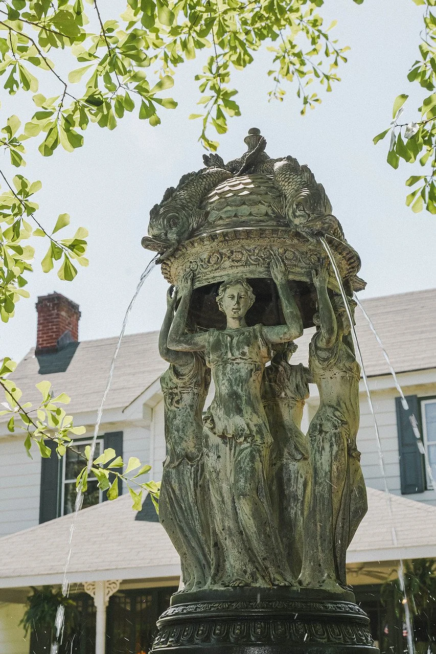 Detailed view of the bronze tiered fountain in front of the historic Manor House | Historic Jasmine, a private wedding venue in New Kent, Virginia.