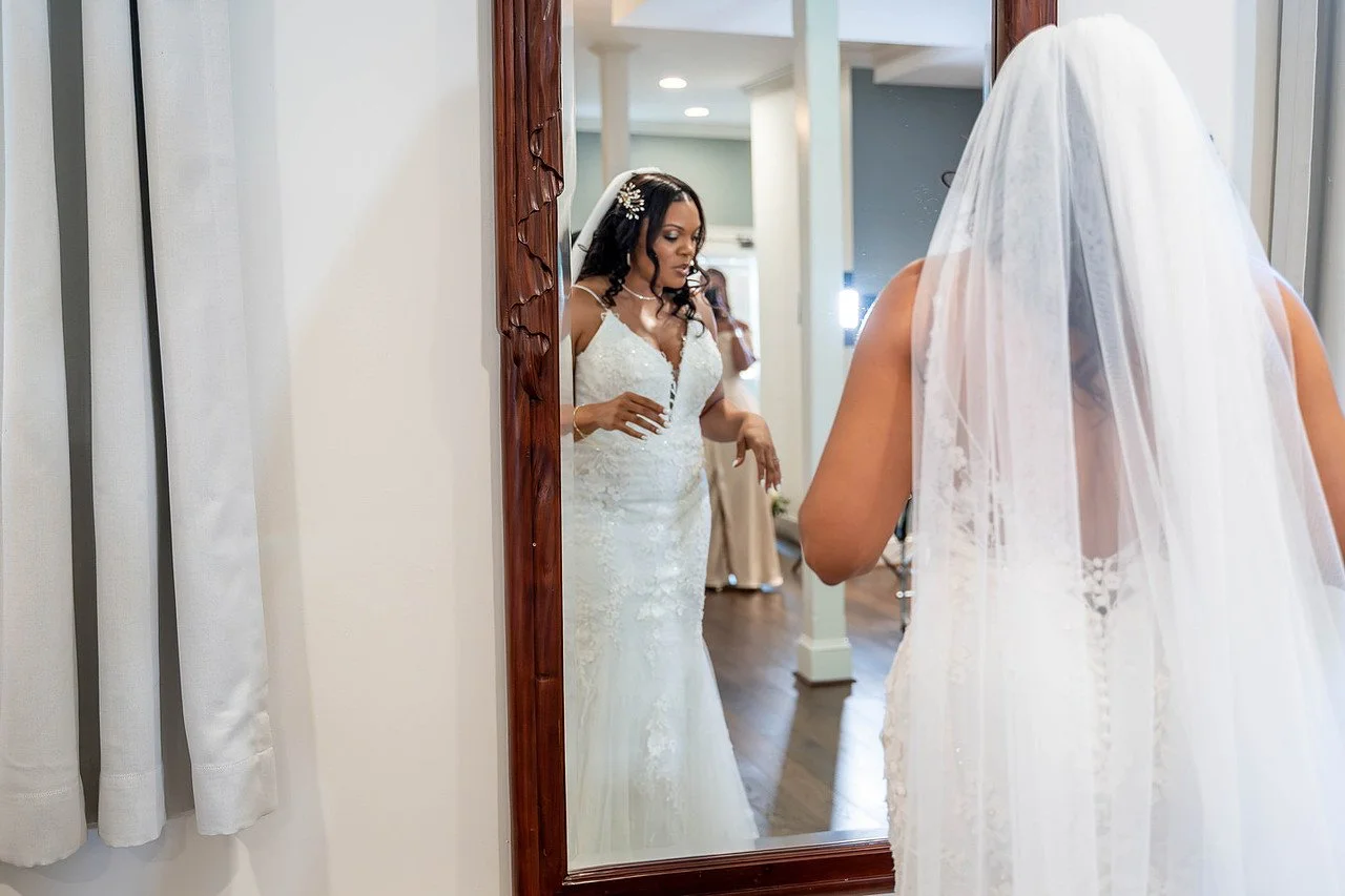 A bride in front of a vintage full length mirror | Historic Jasmine, a private wedding venue in New Kent, Virginia.
