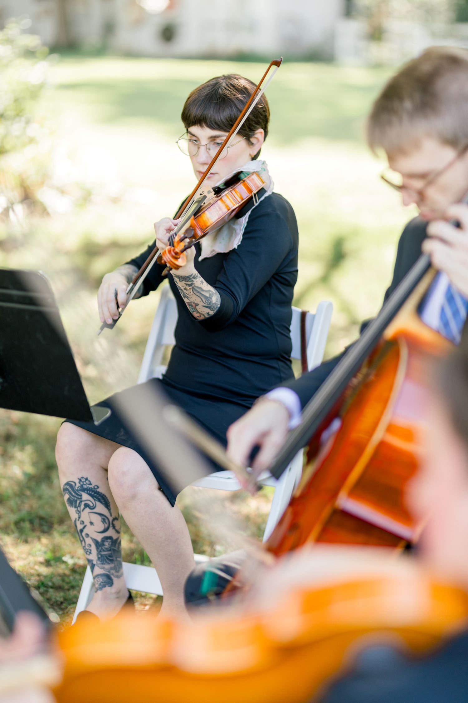 A string quartet plays music at Historic Jasmine, a romantic garden wedding venue near Richmond, Virginia.  