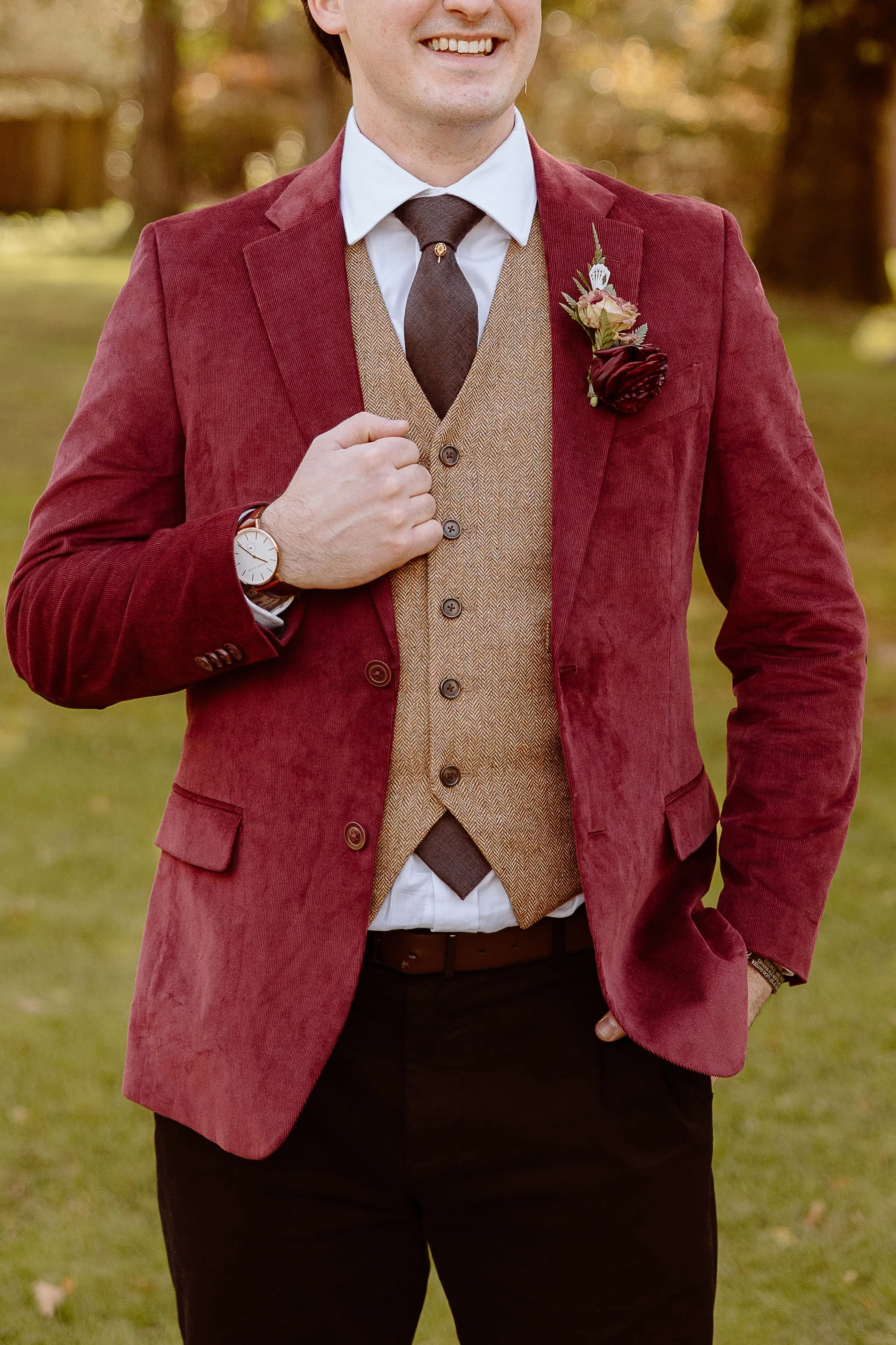 Detailed view of a groom's three piece burgundy suit from a fall wedding event hosted at Historic Jasmine, a private wedding venue located in Greater Richmond, Virginia.