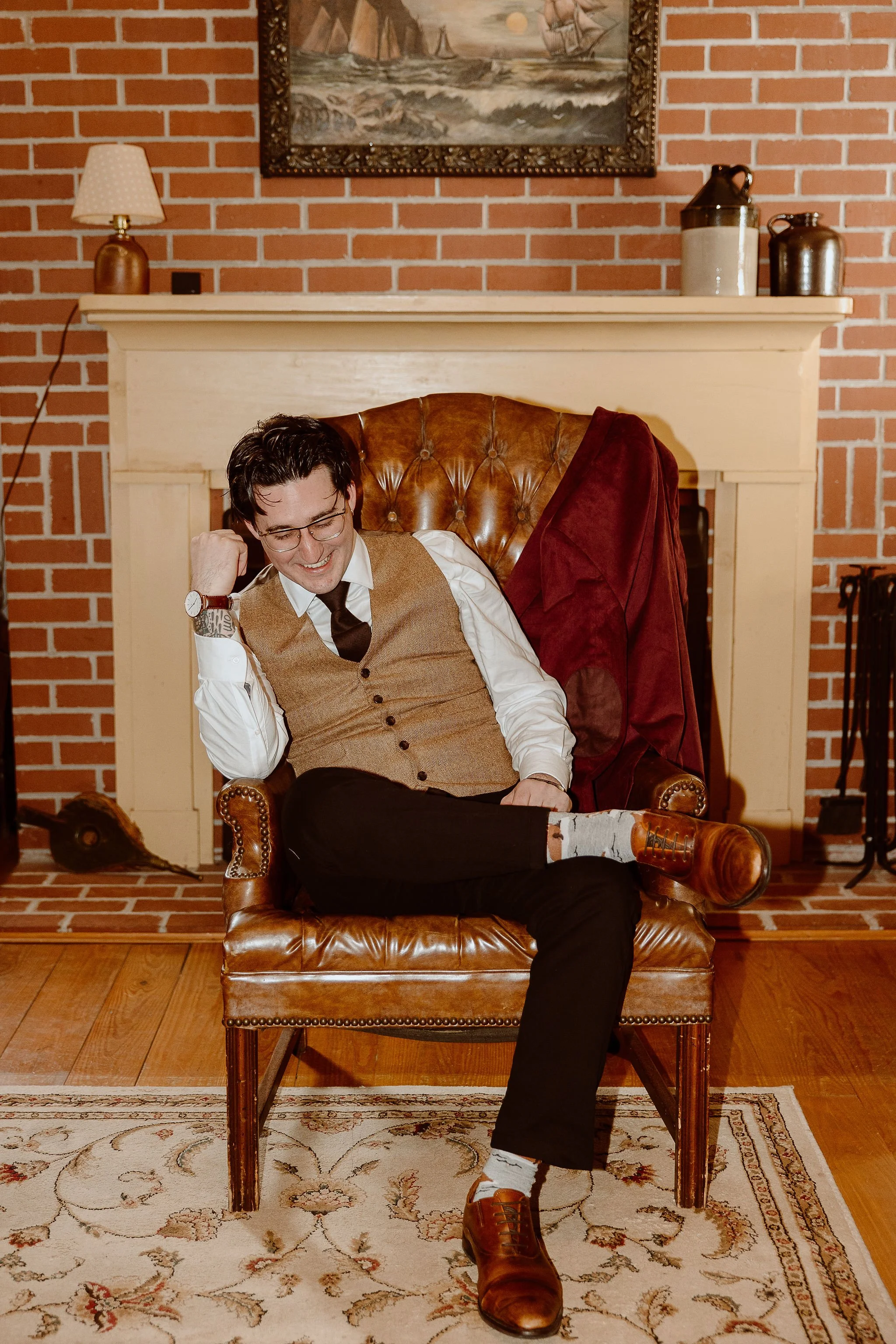 Groom poses in the study changing suite before his wedding ceremony at Historic Jasmine, a private wedding venue in Greater Richmond, Virginia.