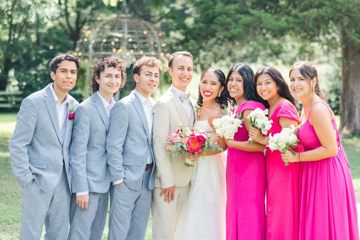 A bridal party poses for a picture at a Summer  wedding hosted at Historic Jasmine, a private estate wedding venue near Richmond, VA.