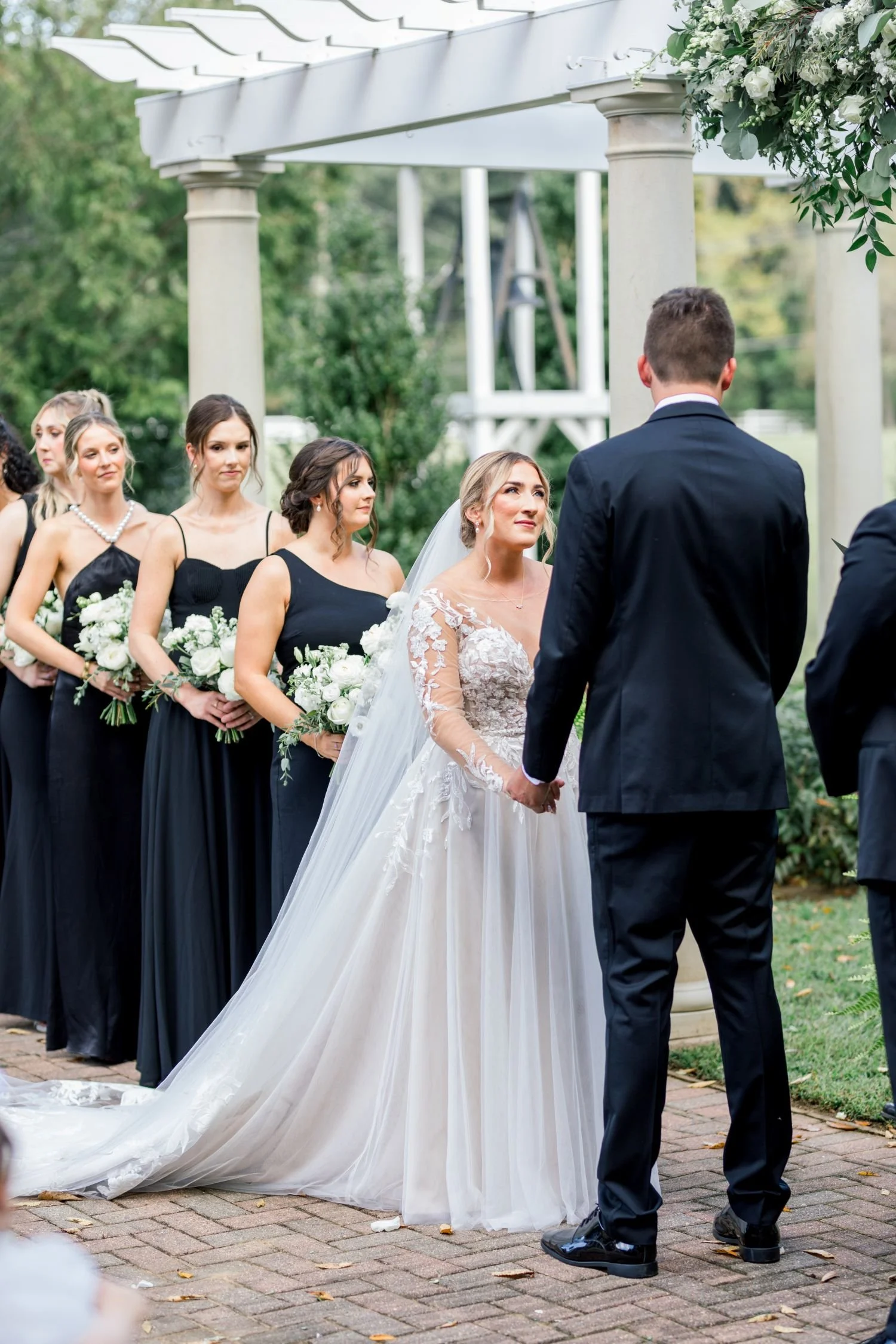 A bride and groom exchange vows at a formal garden wedding located at Historic Jasmine, a private wedding venue in Providence Forge, VA. 