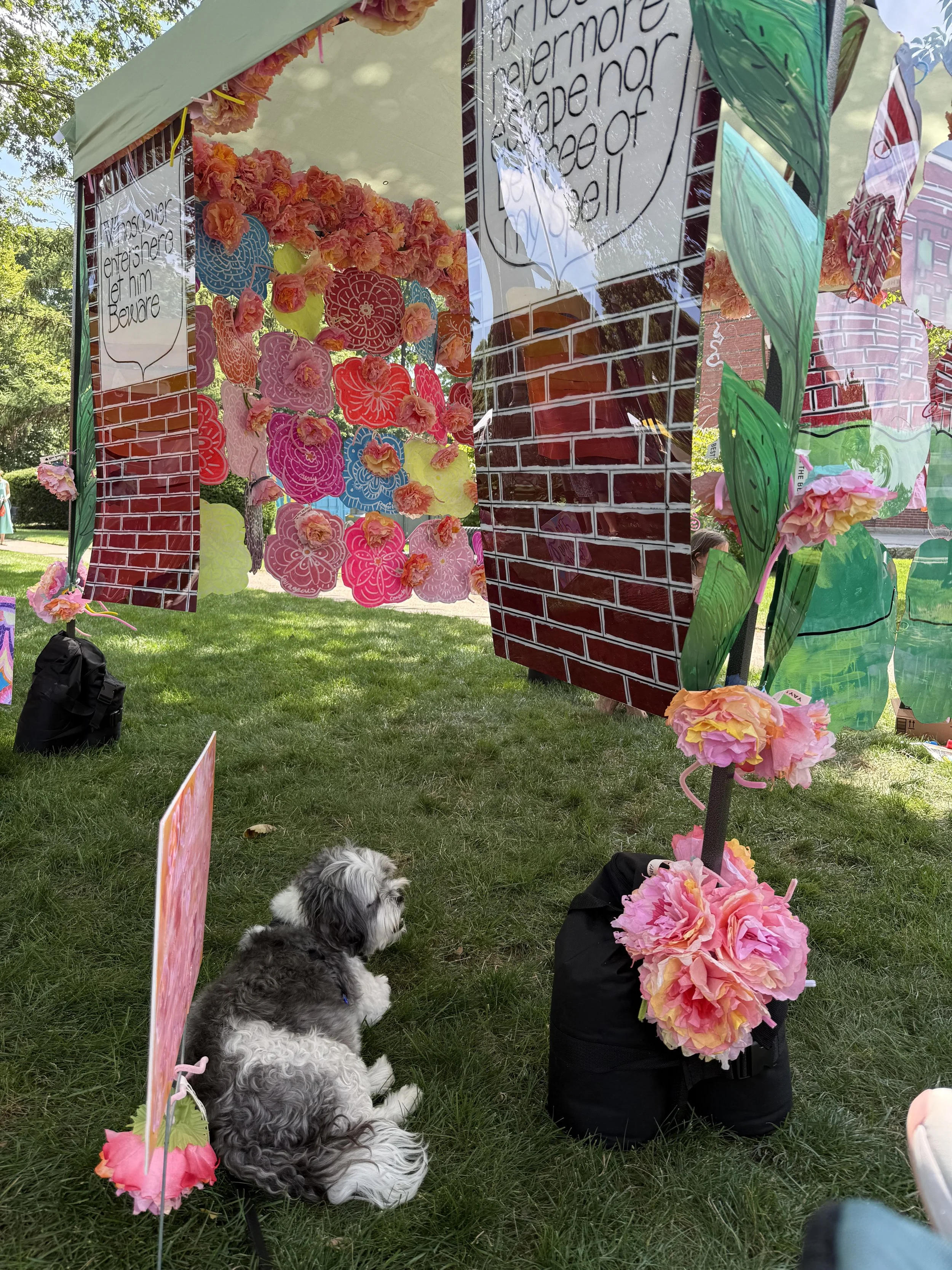 Close-up of a red grid panel with handwritten messages and pink floral decorations.