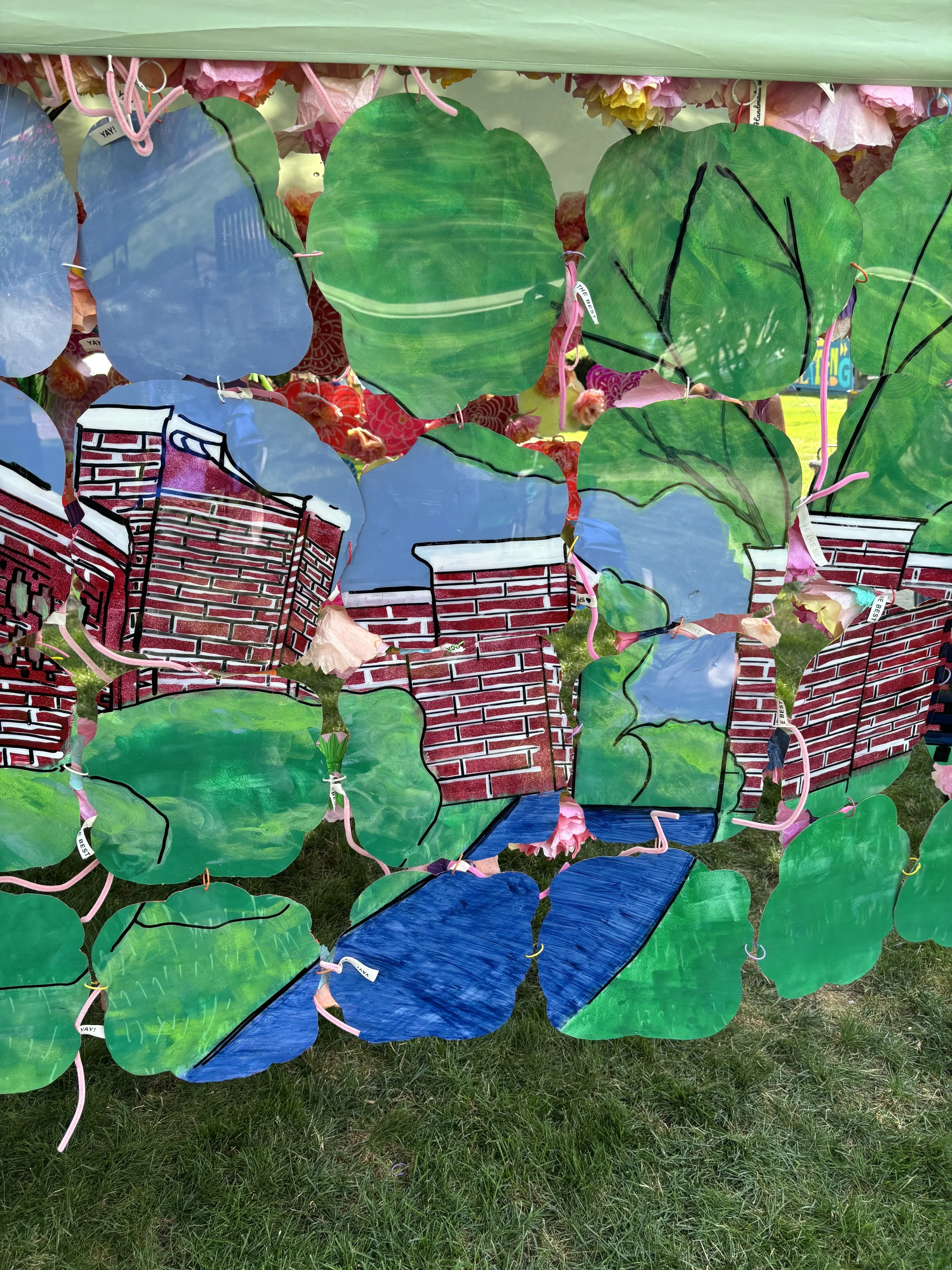 Close-up of layered green, blue, red, and orange painted translucent panels.