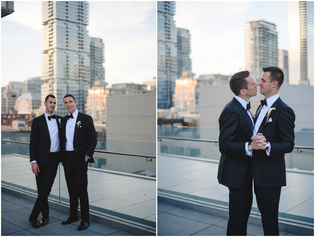 Same sex couple kissing and dancing in the sunset in front of Toronto skyline at Malaparte