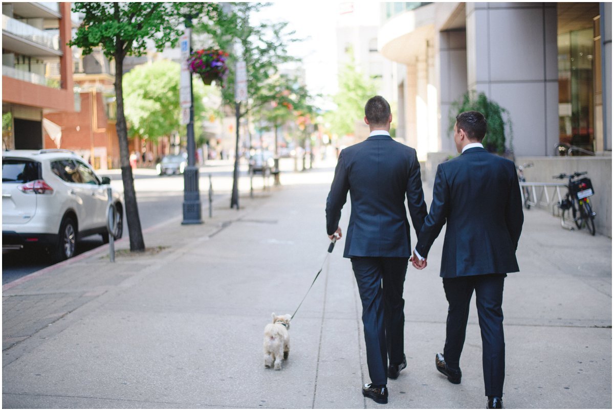 LGBTQ couple walking their dog before their wedding at Malaparte