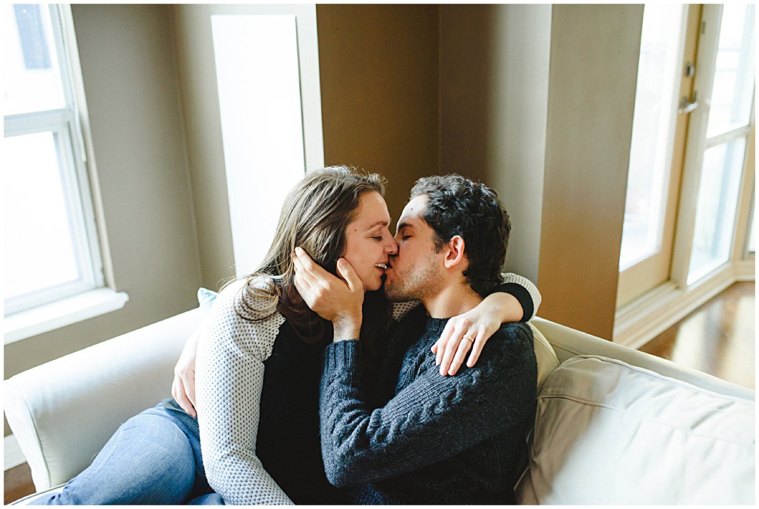 couple kissing on the couch Toronto at home engagement session