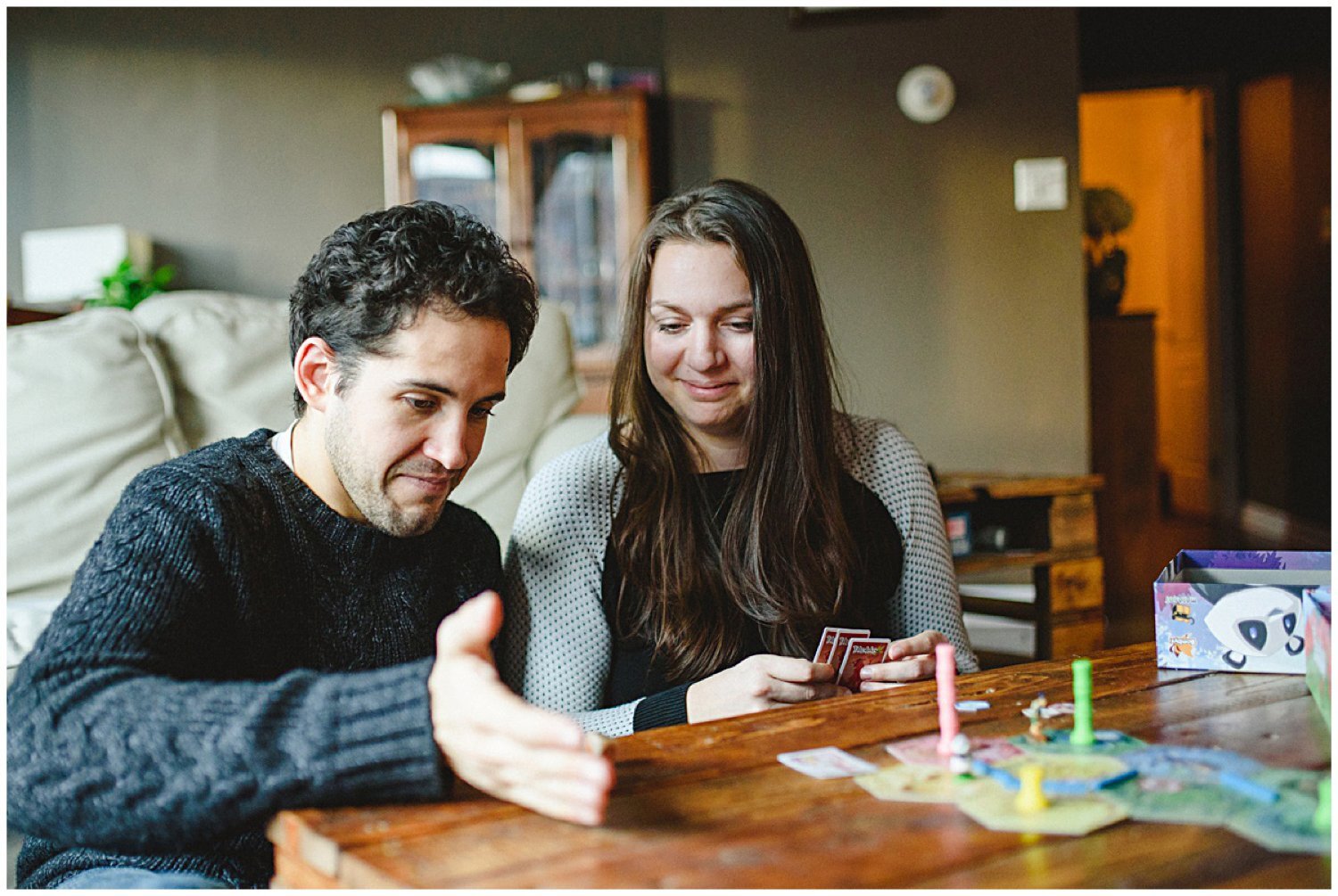 couple playing a board game Toronto at home engagement session