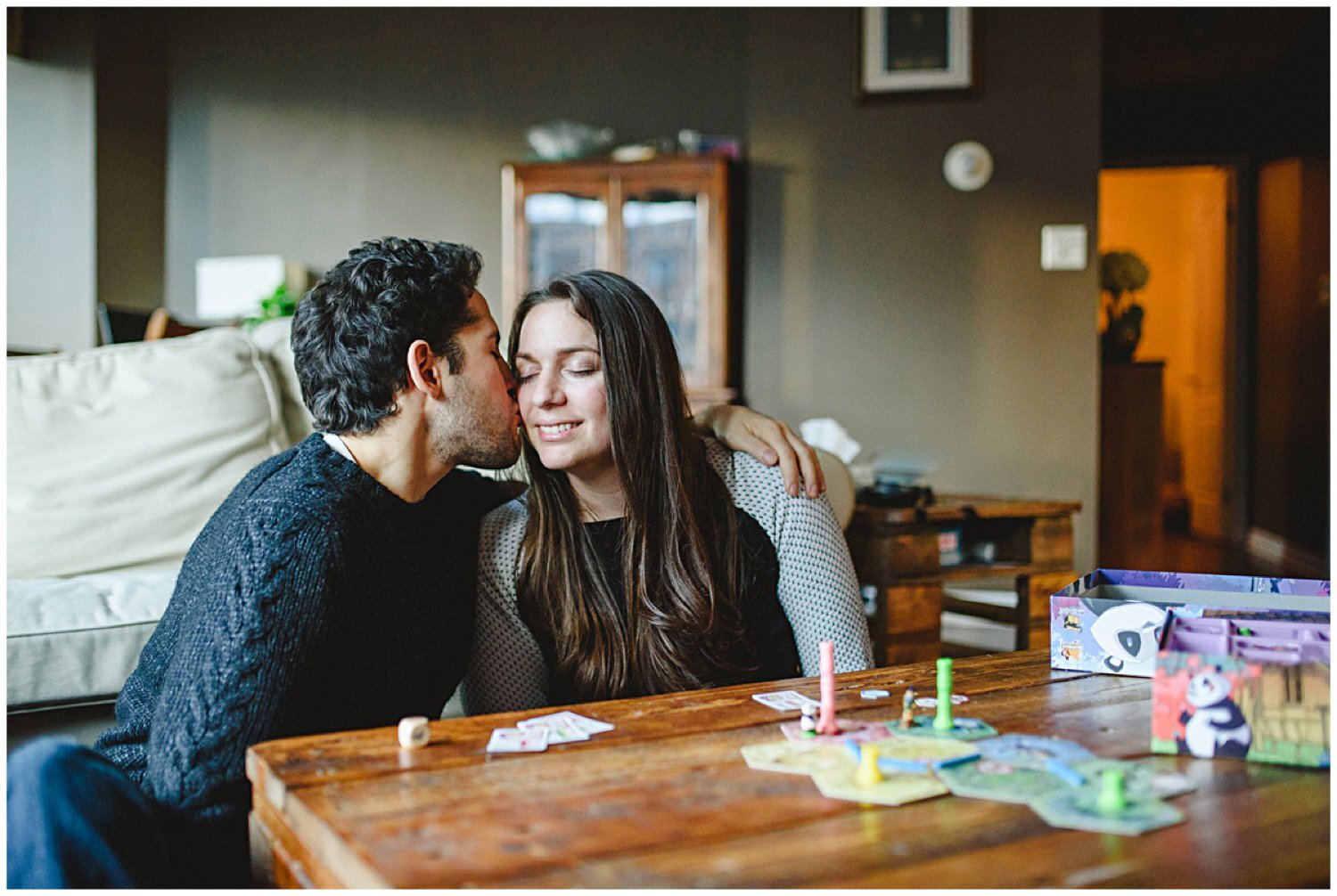 couple playing board game Toronto at home engagement session