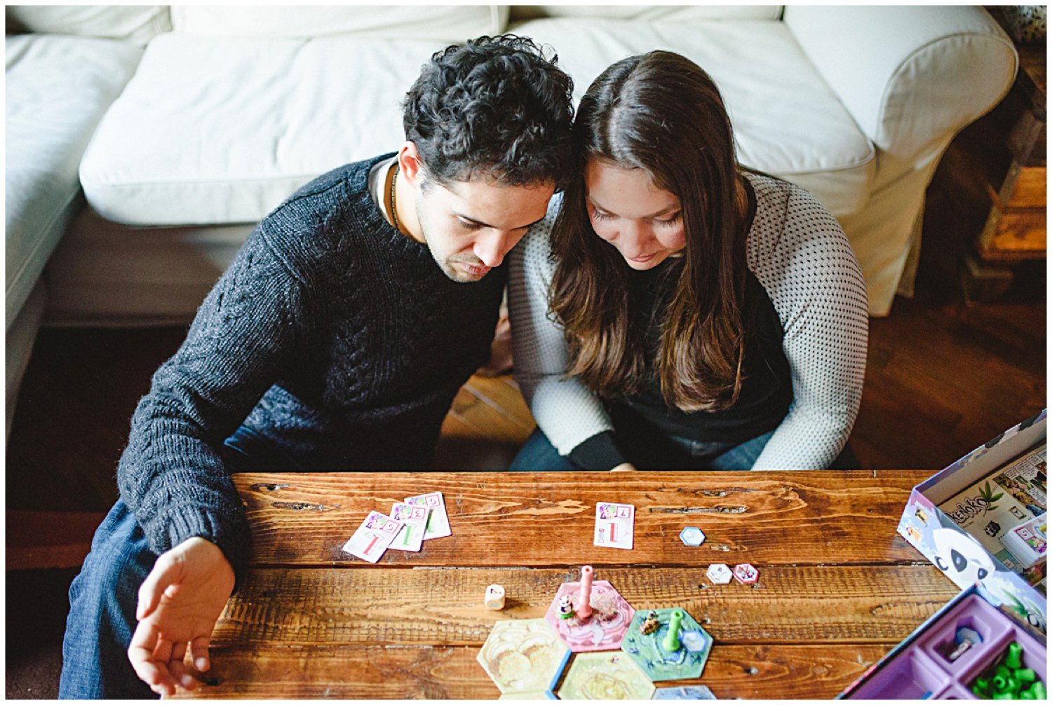 couple playing board game Toronto at home engagement session