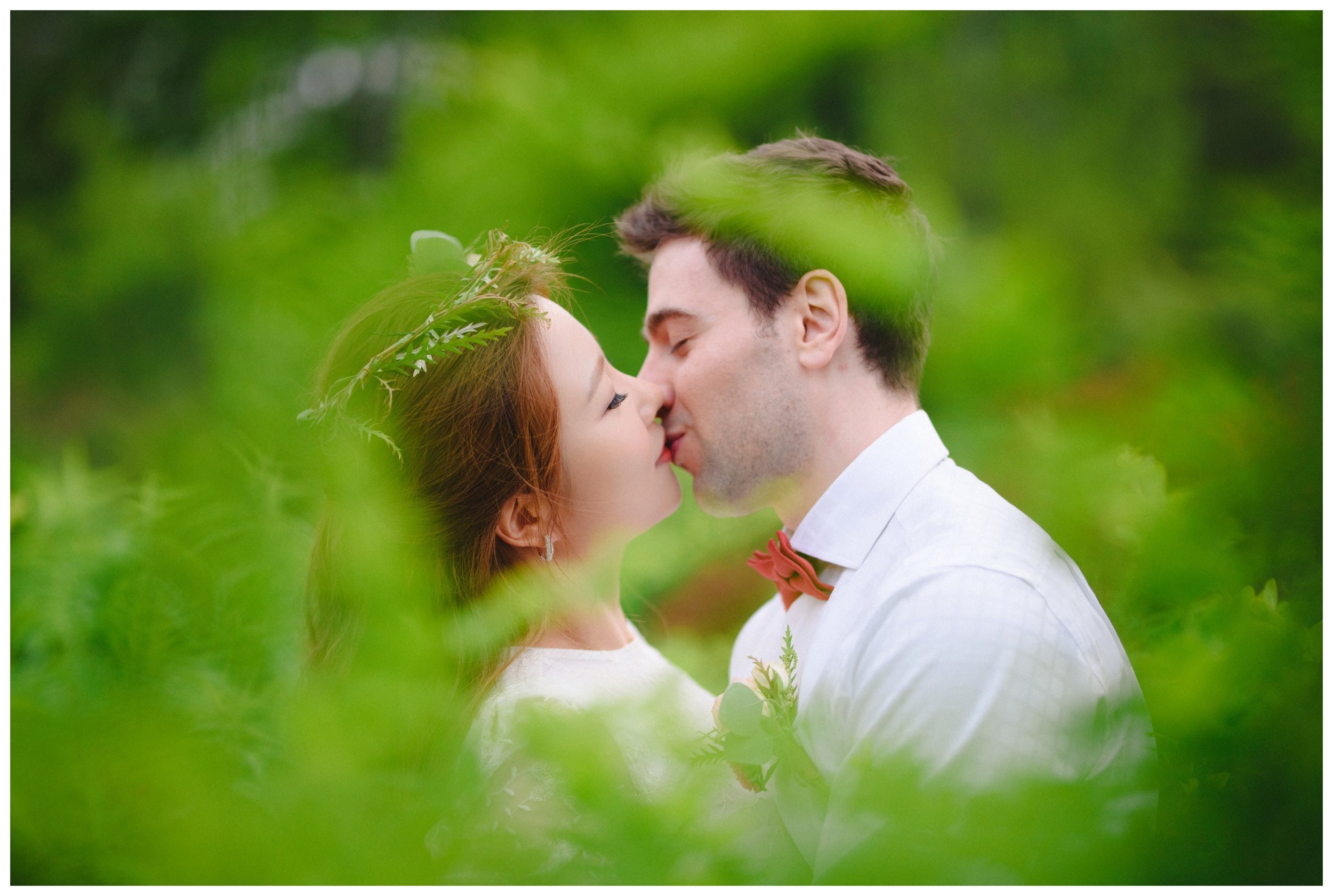 Couple kissing through the bushes Edward Garden engagement session 