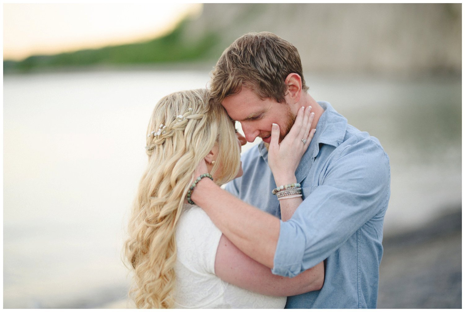 couple embracing on the beach at Scarborough Bluffs engagement 