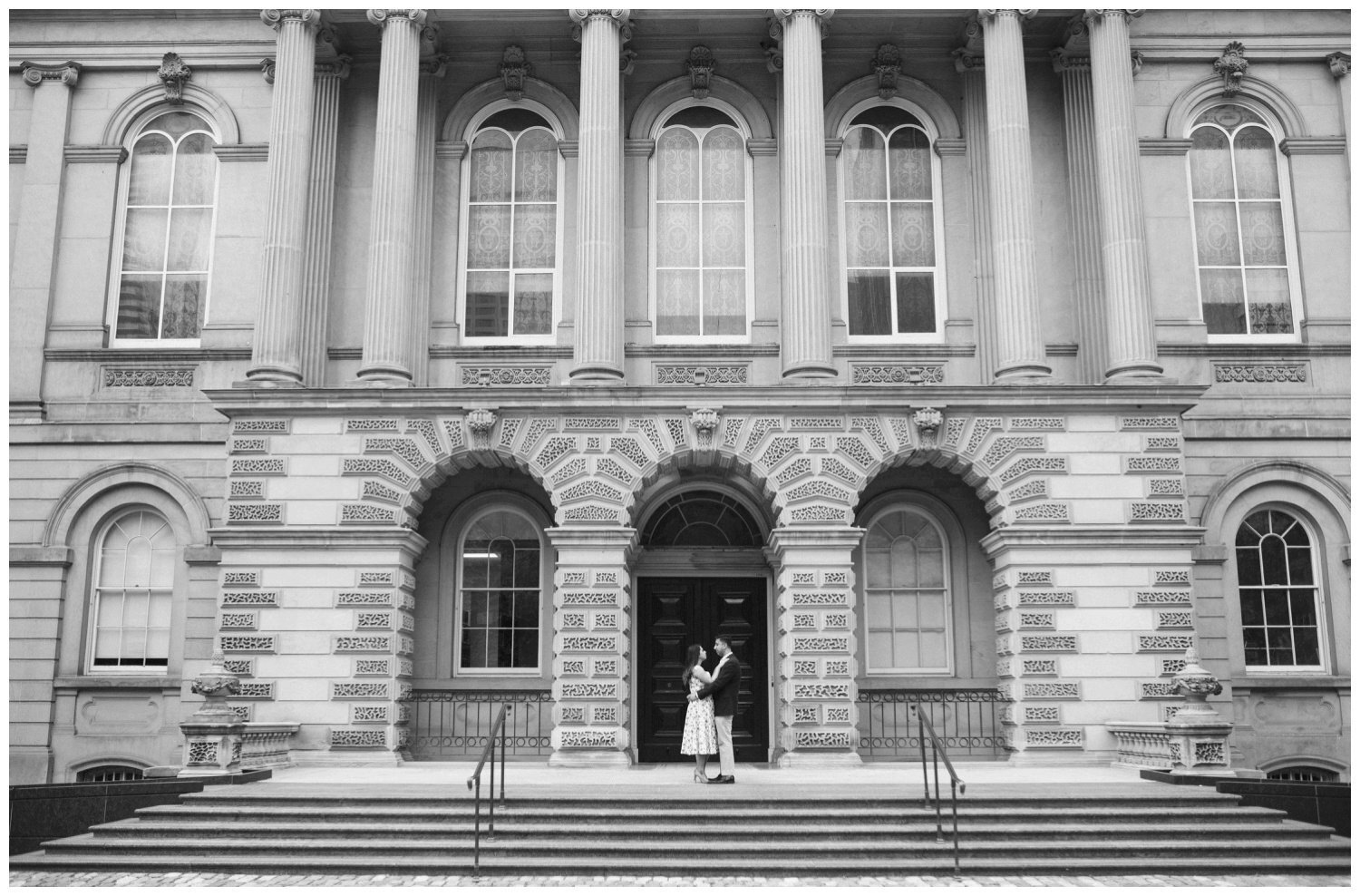 Couple standing on the steps at Osgoode Hall for their engagement 